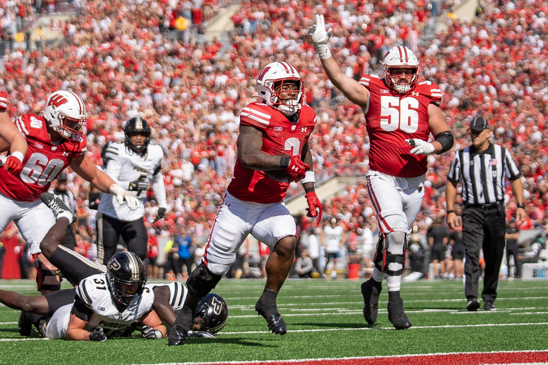 MADISON, WI - OCTOBER 5, 2024: University of Wisconsin Senior RB Tawee Walker (3) on his way to score a TD while University of Wisconsin Redshirt Sophomore OL Joe Brunner (56) celebrates in the background during the Purdue University Boilermakers at University of Wisconsin Badger Football game at Camp Randall Stadium(Photo by Steve Bowen / NISports Report)