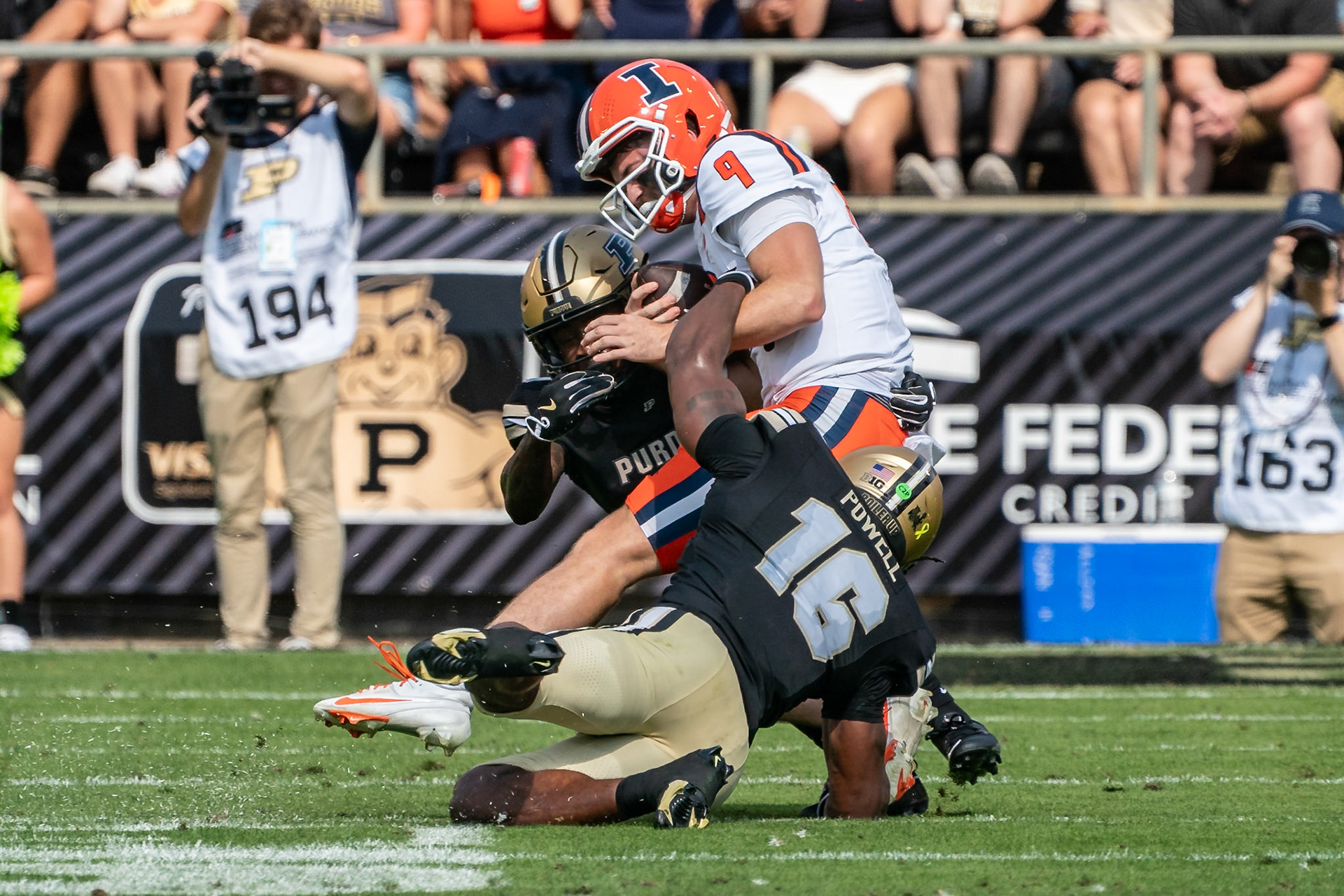 WEST LAFAYETTE, IN - OCTOBER 4, 2025: University of Illinois Senior QB Luke Altmyer (9) gets sandwiched between Purdue University Senior Linebacker Mani Powell (16) and Purdue University Sophomore Defensive Back Traveon Wright (17) in Purdue Boilermaker Football vs University of Illinois Fighting Illini at Ross-Ade Stadium(Photo by Steve Bowen / Northern Indiana Sports Report)