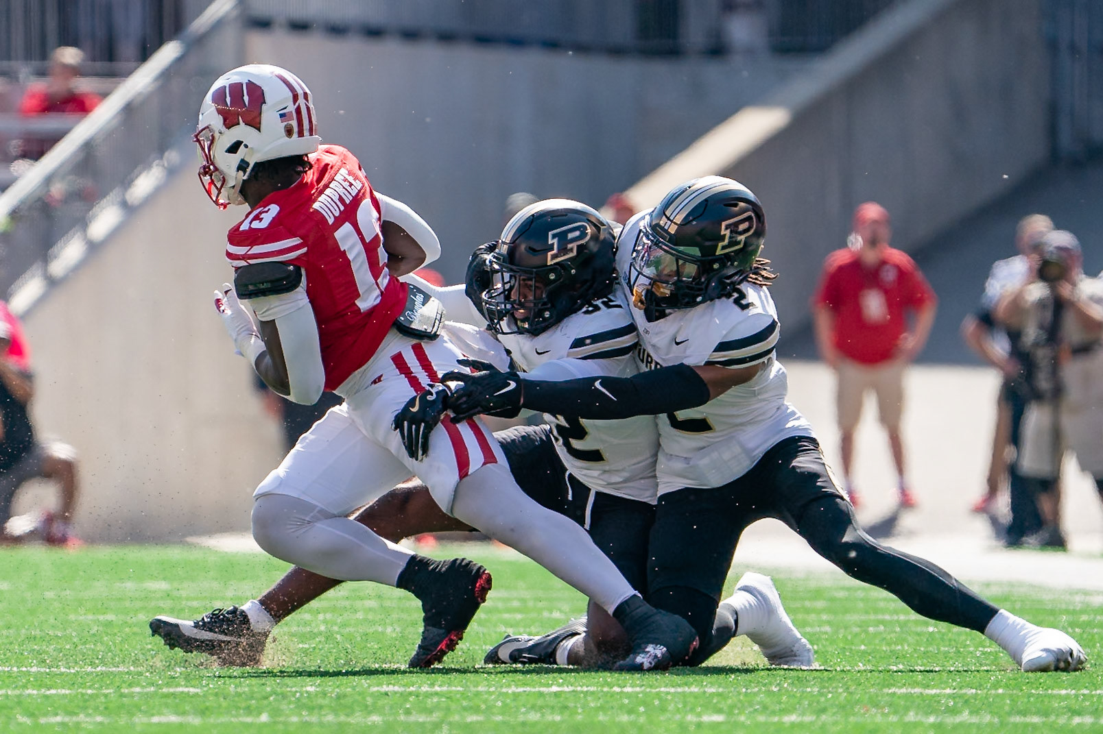 MADISON, WI - OCTOBER 5, 2024: Purdue University Sophomore Defensive Back Joseph Jefferson II (32) and Purdue University Junior Defensive Back Nyland Green (2) trying to tackle University of Wisconsin Freshman RB Darrion Dupree (13) after a catch during the Purdue University Boilermakers at University of Wisconsin Badger Football game at Camp Randall Stadium(Photo by Steve Bowen / NISports Report)