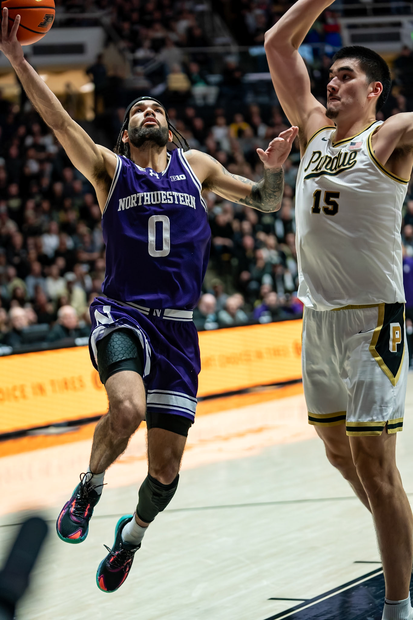 WEST LAFAYETTE, IN - JANUARY 31, 2024: Northwestern Graduate Guard Boo Buie (0), Purdue Senior Center Zach Edey (15) competing in Purdue Boilermakers Mens Basketball versus the Northwestern Wildcats at Mackey Arena(Photo by Steve Bowen / Bowen Arrow Photography / Northern Indiana Sports Report)