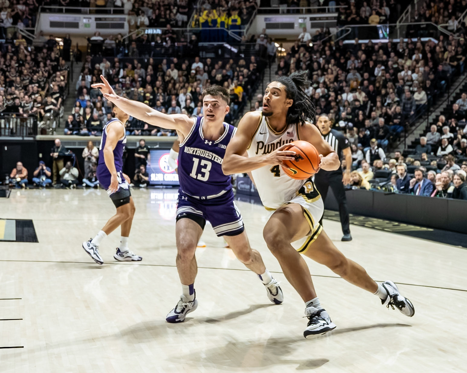 WEST LAFAYETTE, IN - JANUARY 31, 2024: Purdue Sophomore Forward Trey Kaufman-Renn (4), Northwestern Junior Guard Brooks Barnhizer (13) competing in Purdue Boilermakers Mens Basketball versus the Northwestern Wildcats at Mackey Arena(Photo by Steve Bowen / Bowen Arrow Photography / Northern Indiana Sports Report)