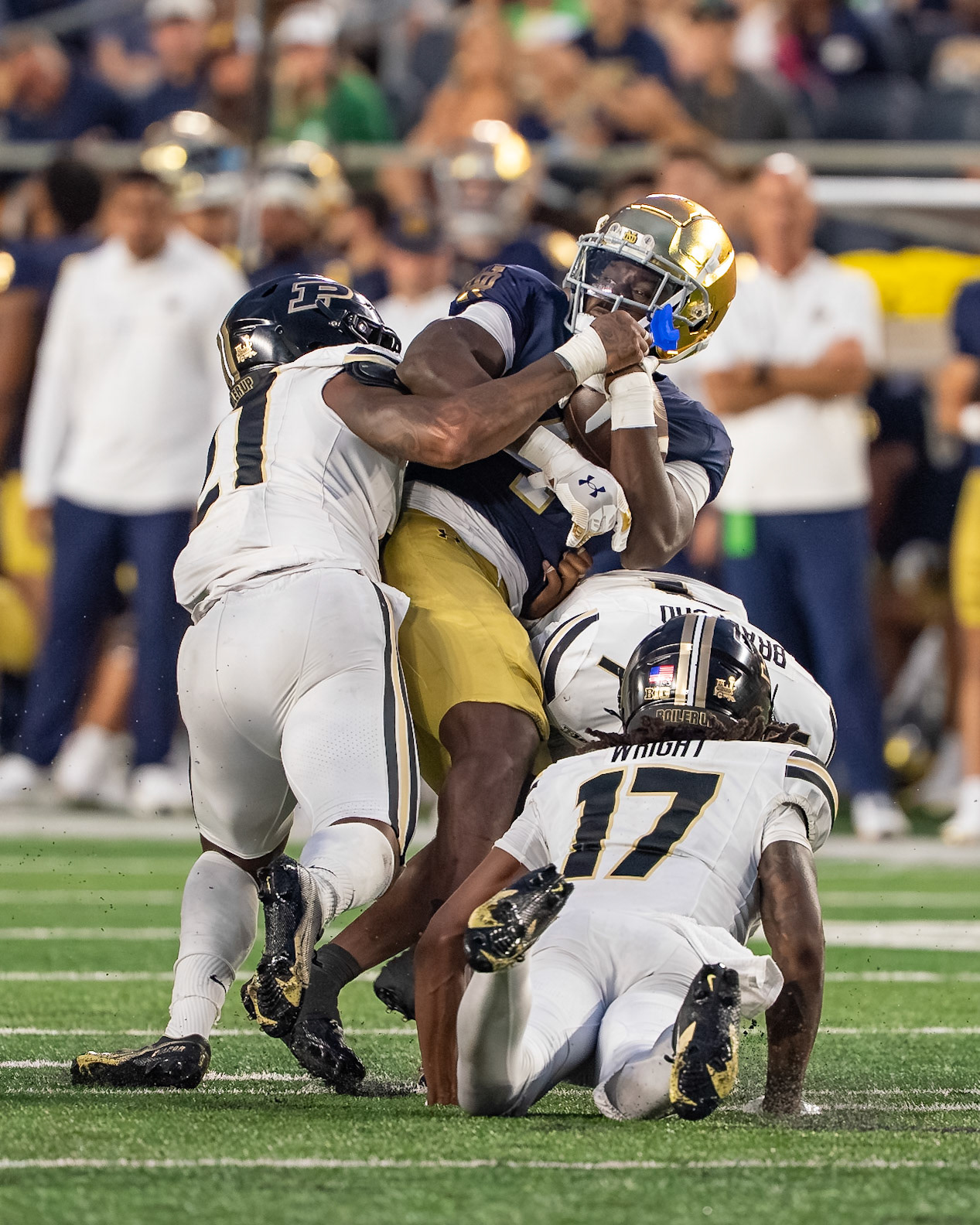 SOUTH BEND, IN - SEPTEMBER 20, 2025: Notre Dame University Junior RB Jeremiyah Love (4) gets sandwiched between Purdue University Sophomore Defensive Back Traveon Wright (17), Purdue University Senior Defensive Back Tahj Ra-El (21) and Purdue University Sophomore Defensive Back Smiley Bradford (1) in Purdue Boilermakers at Notre Dame Fighting Irish Football at Notre Dame Stadium(Photo by Steve Bowen / Northern Indiana Sports Report)