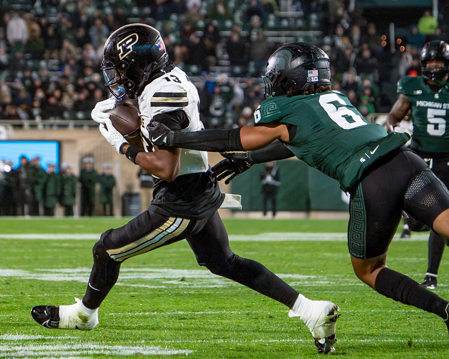 EAST LANSING, MI - NOVEMBER 22, 2024: Purdue University Sophomore Wide Receiver Jaron Tibbs (13), Purdue University Freshman Defensive Back Smiley Bradford (6) in Purdue University Boilermakers at Michigan State University Spartans Football game at Spartan Stadium(Photo by Steve Bowen / Bowen Arrow Photography / Northern Indiana Sports Report)