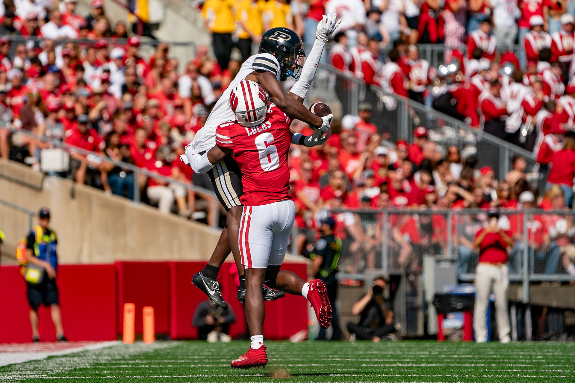 MADISON, WI - OCTOBER 5, 2024: Purdue University Sophomore Wide Receiver Jaron Tibbs (13) trying to catch a pass while being defended by University of Wisconsin Redshirt Junior WR Will Pauling (6) during the Purdue University Boilermakers at University of Wisconsin Badger Football game at Camp Randall Stadium(Photo by Steve Bowen / NISports Report)