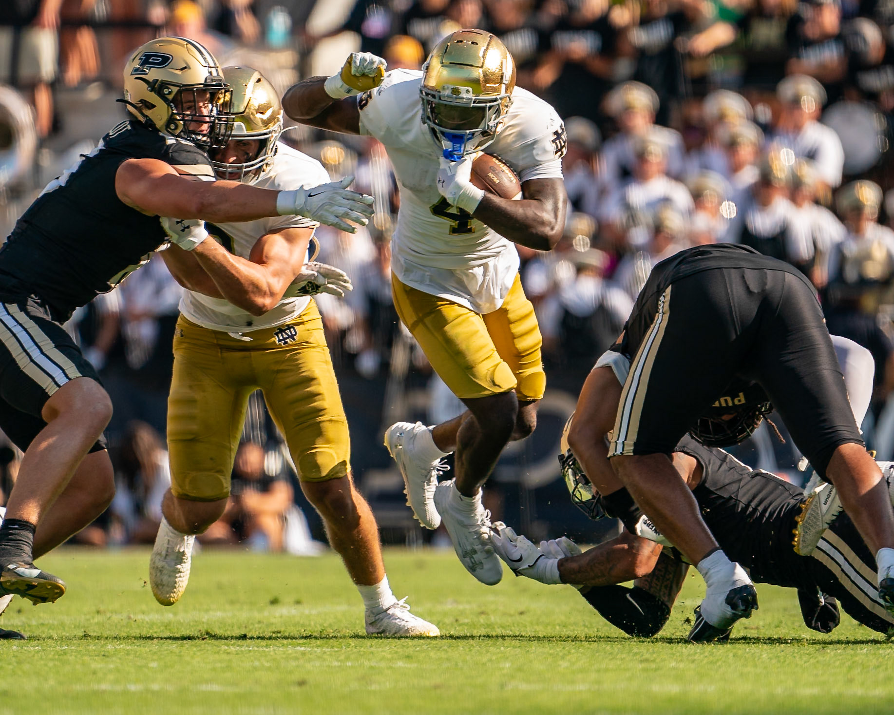 WEST LAFAYETTE, IN - SEPTEMBER 14, 2024: Notre Dame Sophomore RB Jeremiyah Love (4), Purdue So. Rush End Will Heldt (15), Purdue Sr. Defensive Back Antonio Stevens (11), Purdue Sr. Linebacker Kydran Jenkins (4) during the Purdue University Boilermakers vs Notre Dame Fighting Irish Football game at Ross-Ade Stadium(Photo by Steve Bowen / Bowen Arrow Photography / Northern Indiana Sports Report)