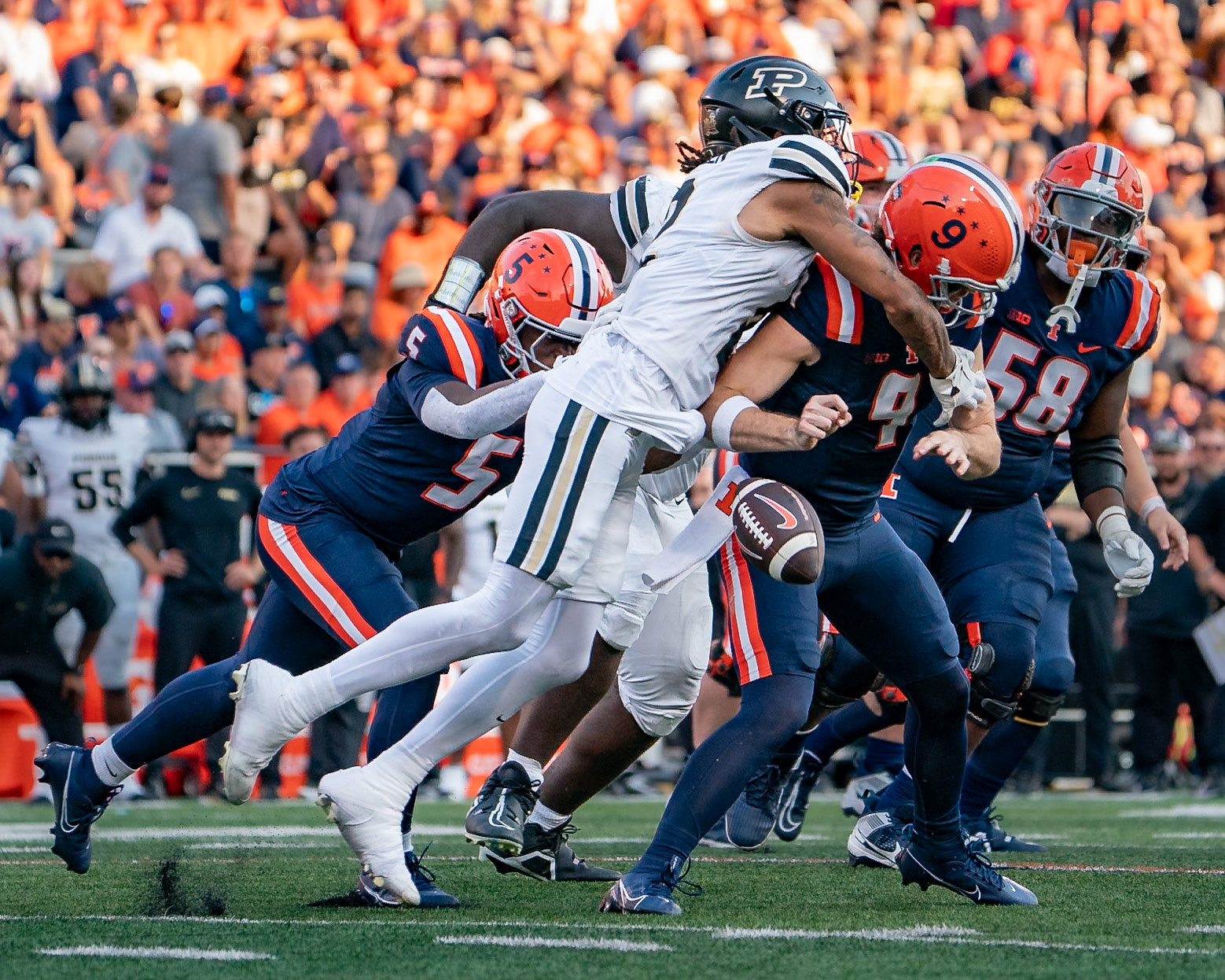 CHAMPAIGN, IL - OCTOBER 12, 2024: Purdue University Junior Defensive Back Nyland Green (2), University of Illinois Junior QB Luke Altmyer (9), University of Illinois Freshman RB Ca'Lil Valentine (5) during the Purdue University Boilermakers at University of Illinois Fighting Illini Football game at Memorial Stadium(Photo by Steve Bowen / Bowen Arrow Photography / Northern Indiana Sports Report)