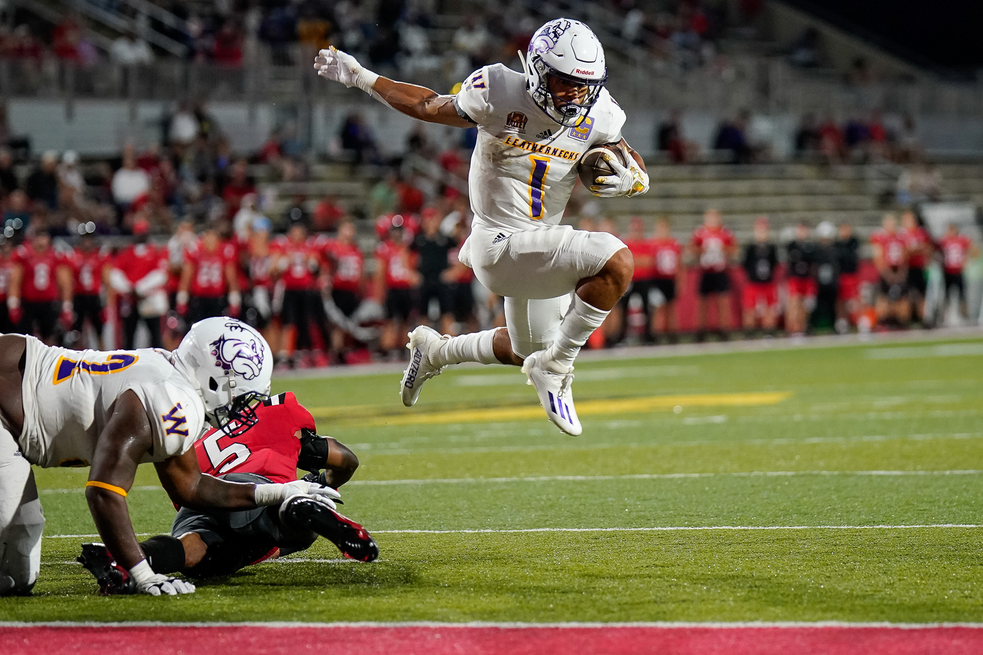 WIU's Tony Tate leaps over a defender on his way to the end zone