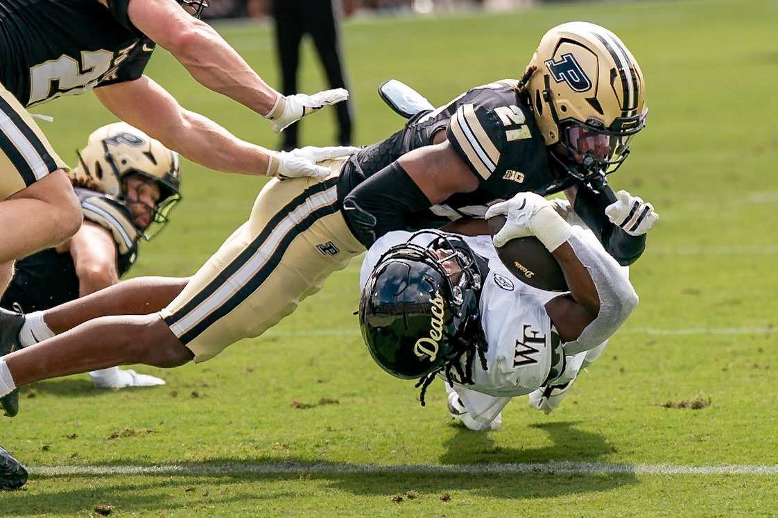 WEST LAFAYETTE, IN - SEPTEMBER 12, 2026: Wake Forest University Running Back Ty Clark III (4) rolls back into the end zone for a touchdown out of the grasp of Purdue University Sophomore Defensive Back Justin Denson Jr. (21) during the Purdue Boilermaker Football vs the Wake Forest Demon Deacons at Ross-Ade Stadium(Photo by Steve Bowen / Northern Indiana Sports Report)