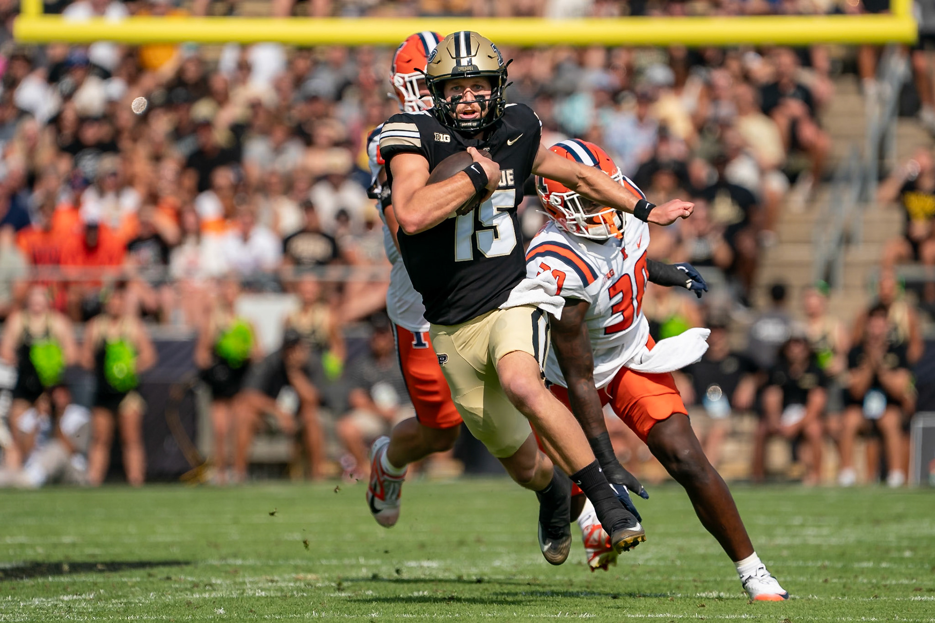 WEST LAFAYETTE, IN - OCTOBER 4, 2025: Purdue University Sophomore Quarterback Ryan Browne (15) gets past an outstretched University of Illinois Sophomore LB Jojo Hayden (30) in Purdue Boilermaker Football vs University of Illinois Fighting Illini at Ross-Ade Stadium(Photo by Steve Bowen / Northern Indiana Sports Report)