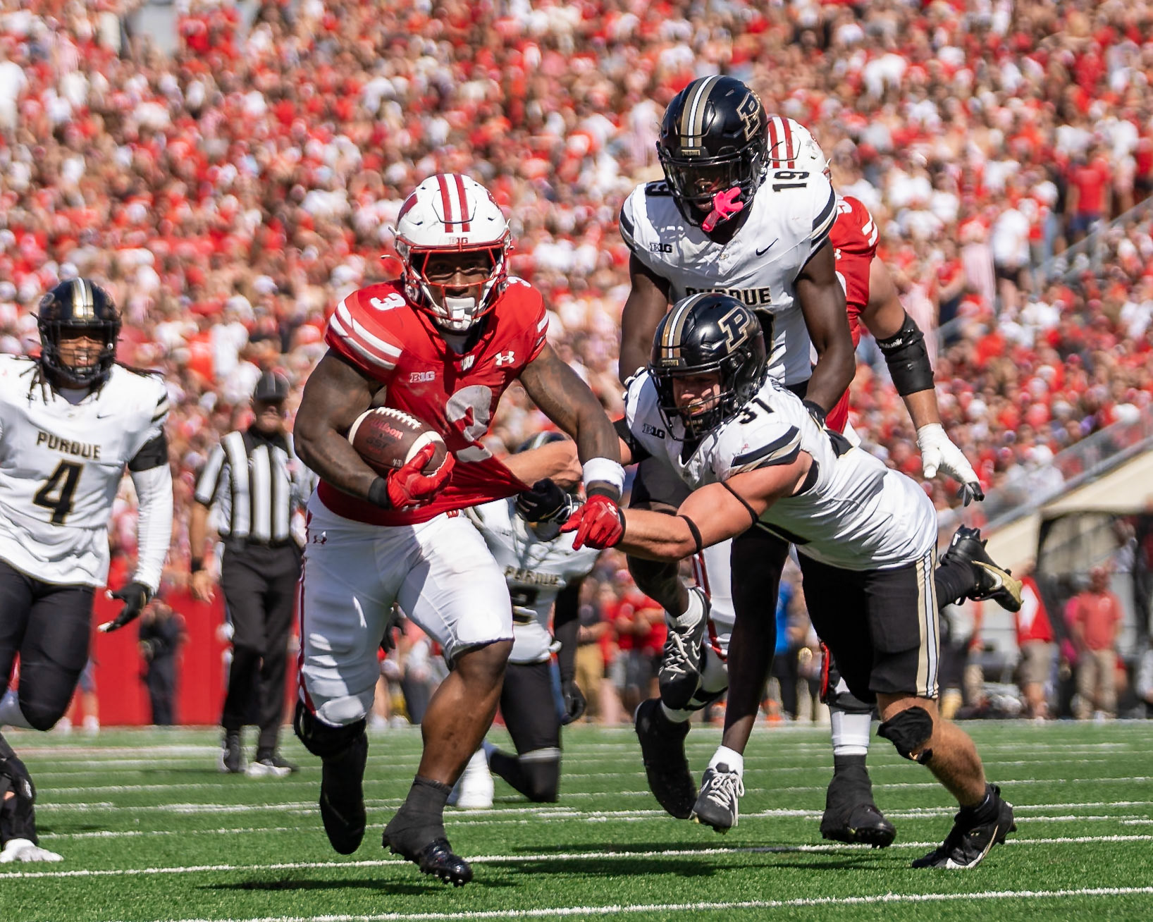 MADISON, WI - OCTOBER 5, 2024: University of Wisconsin Senior RB Tawee Walker (3) on a run while Purdue University Sophomore Defensive Back Dillon Thieneman (31) tries to tackle him during the Purdue University Boilermakers at University of Wisconsin Badger Football game at Camp Randall Stadium(Photo by Steve Bowen / NISports Report)