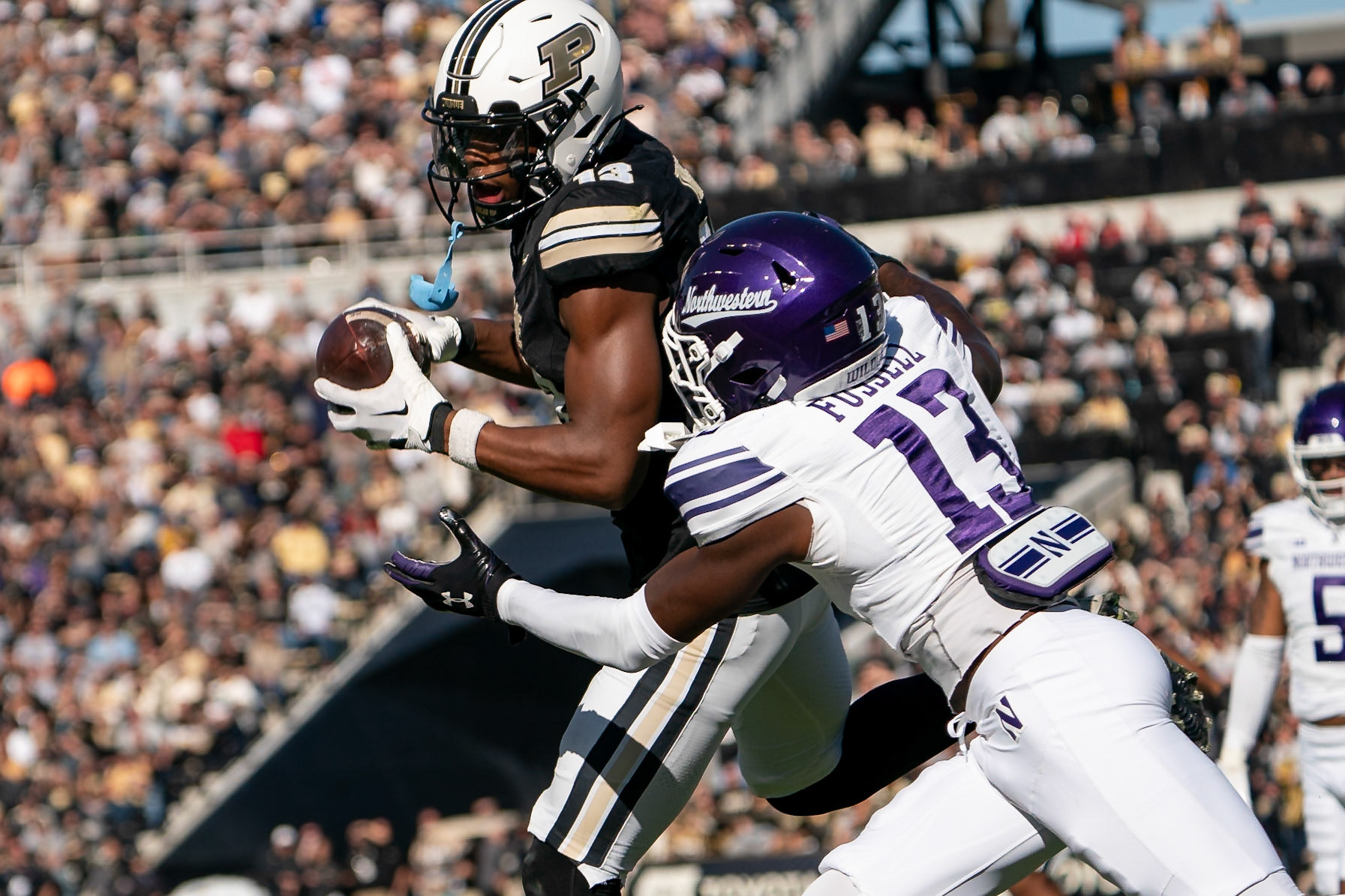 WEST LAFAYETTE, IN - NOVEMBER 2, 2024: Purdue University Sophomore Wide Receiver Jaron Tibbs (13) catches a pass at the goaline while Northwestern University Defensive Back Josh Fussell (13) goes in for the tackle during the Purdue University Boilermakers vs Northwestern University Wildcats Football game at Ross-Ade Stadium(Photo by Steve Bowen / Bowen Arrow Photography / Northern Indiana Sports Report)