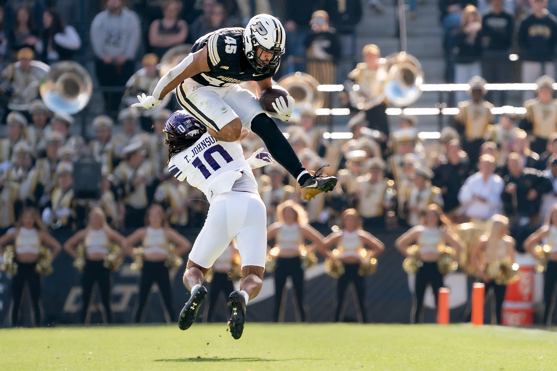 WEST LAFAYETTE, IN - NOVEMBER 2, 2024: Purdue University Junior Running Back Devin Mockobee (45) jumps over Northwestern University Defensive Back Theran Johnson (10) during the Purdue University Boilermakers vs Northwestern University Wildcats Football game at Ross-Ade Stadium(Photo by Steve Bowen / Bowen Arrow Photography / Northern Indiana Sports Report)