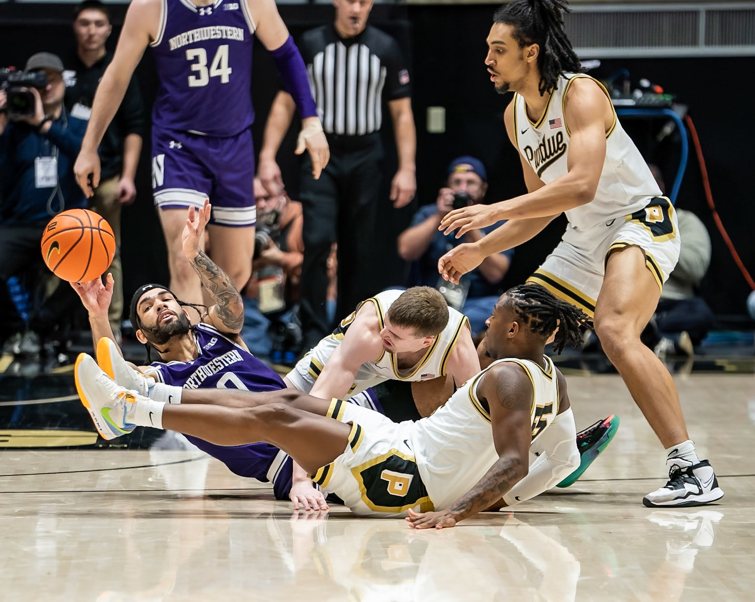 WEST LAFAYETTE, IN - JANUARY 31, 2024: Northwestern Graduate Guard Boo Buie (0), Purdue Sophomore Guard Braden Smith (3), Purdue 5th year Guard Lance Jones (55), Purdue Sophomore Forward Trey Kaufman-Renn (4) competing in Purdue Boilermakers Mens Basketball versus the Northwestern Wildcats at Mackey Arena(Photo by Steve Bowen / Bowen Arrow Photography / Northern Indiana Sports Report)