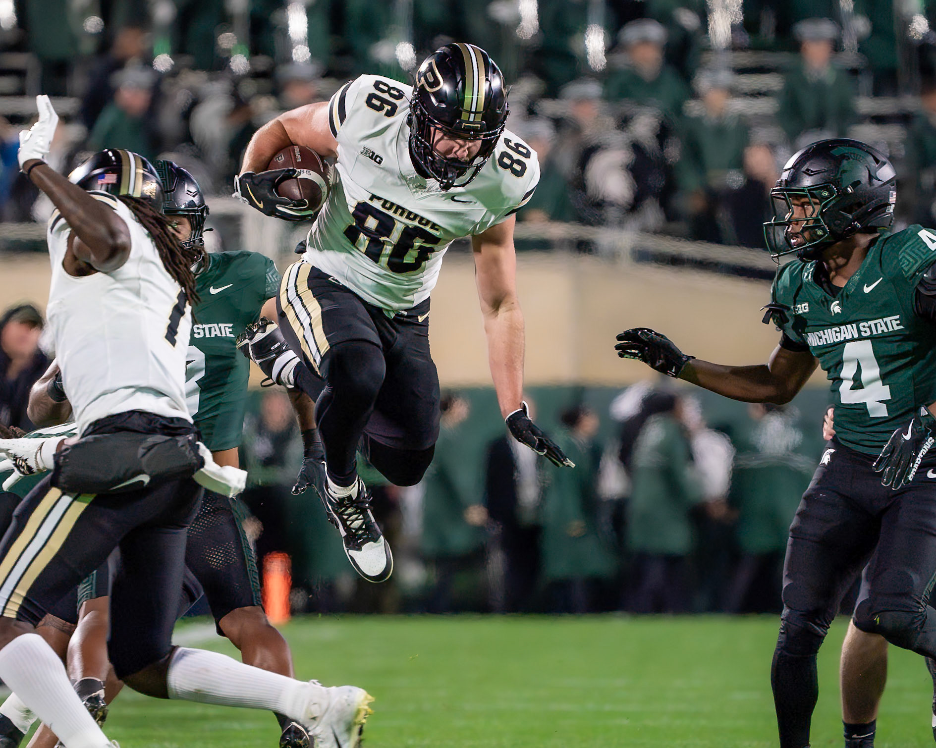 EAST LANSING, MI - NOVEMBER 22, 2024: Purdue University Sophomore Tight End Max Klare (86) jumps to avoid a defender during the Purdue University Boilermakers at Michigan State University Spartans Football game at Spartan Stadium(Photo by Steve Bowen / Bowen Arrow Photography / Northern Indiana Sports Report)