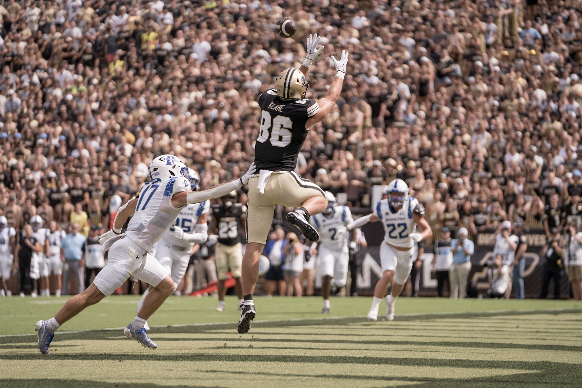WEST LAFAYETTE, IN - AUGUST 31, 2024: Purdue So. TE Max Klare (86) leaps to grab a 1st quarter touchdown while Indiana State R-Jr. DB Maddix Blackwell (17) chases him in Purdue Boilermaker Football vs Indiana State Sycamores at Ross-Ade Stadium(Photo by Steve Bowen / Bowen Arrow Photography / Northern Indiana Sports Report)