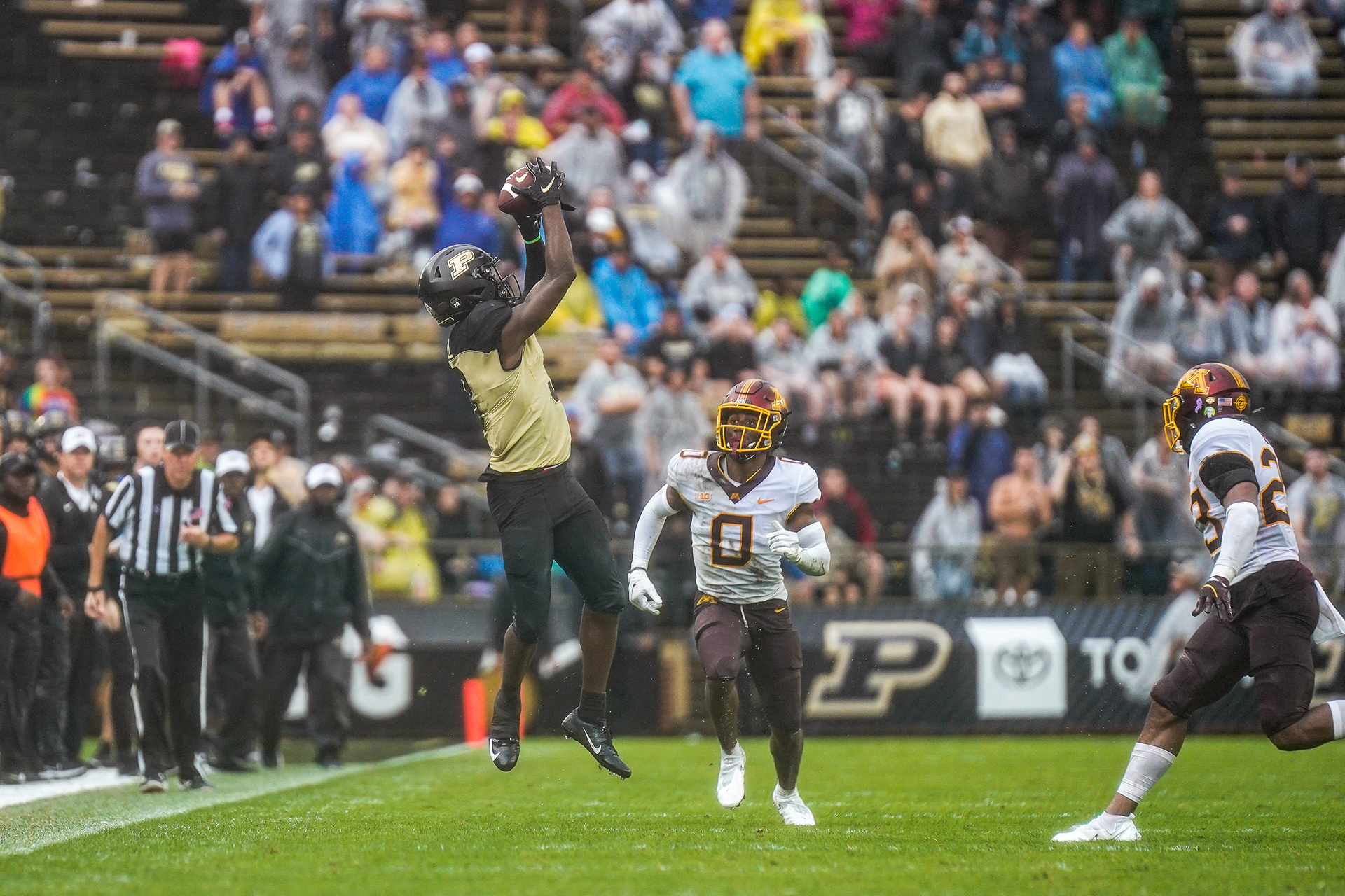 Purdue leaps up to make the catch while Justin Walley (0) looks on