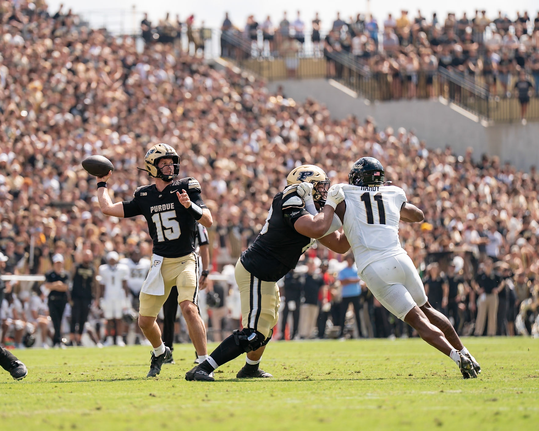 WEST LAFAYETTE, IN - SEPTEMBER 12, 2026: Purdue University Quarterback Ryan Browne (15) throwing towards the end zone as Sophomore Offensive Lineman Nuku Mafi (68) keeps Wake Forest University Defensive Lineman Langston Hardy (11) at bay during the Purdue Boilermakers football game vs the Wake Forest Demon Deacons at Ross-Ade Stadium(Photo by Steve Bowen / Northern Indiana Sports Report)