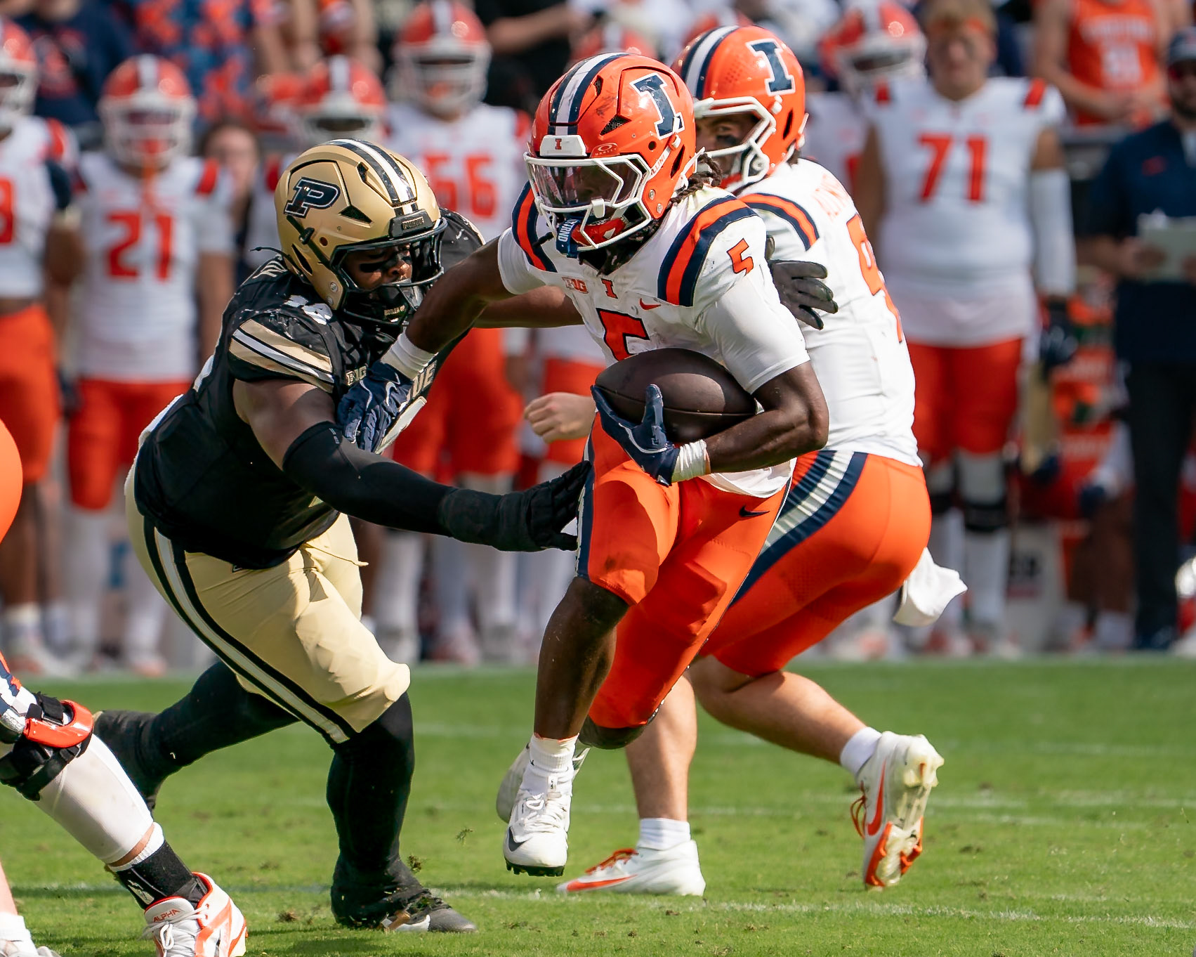 WEST LAFAYETTE, IN - OCTOBER 4, 2025: University of Illinois Sophomore RB Ca'Lil Valentine (5) running past Purdue University Sophomore Defensive Lineman Demeco Kennedy (18) in Purdue Boilermaker Football vs University of Illinois Fighting Illini at Ross-Ade Stadium(Photo by Steve Bowen / Northern Indiana Sports Report)
