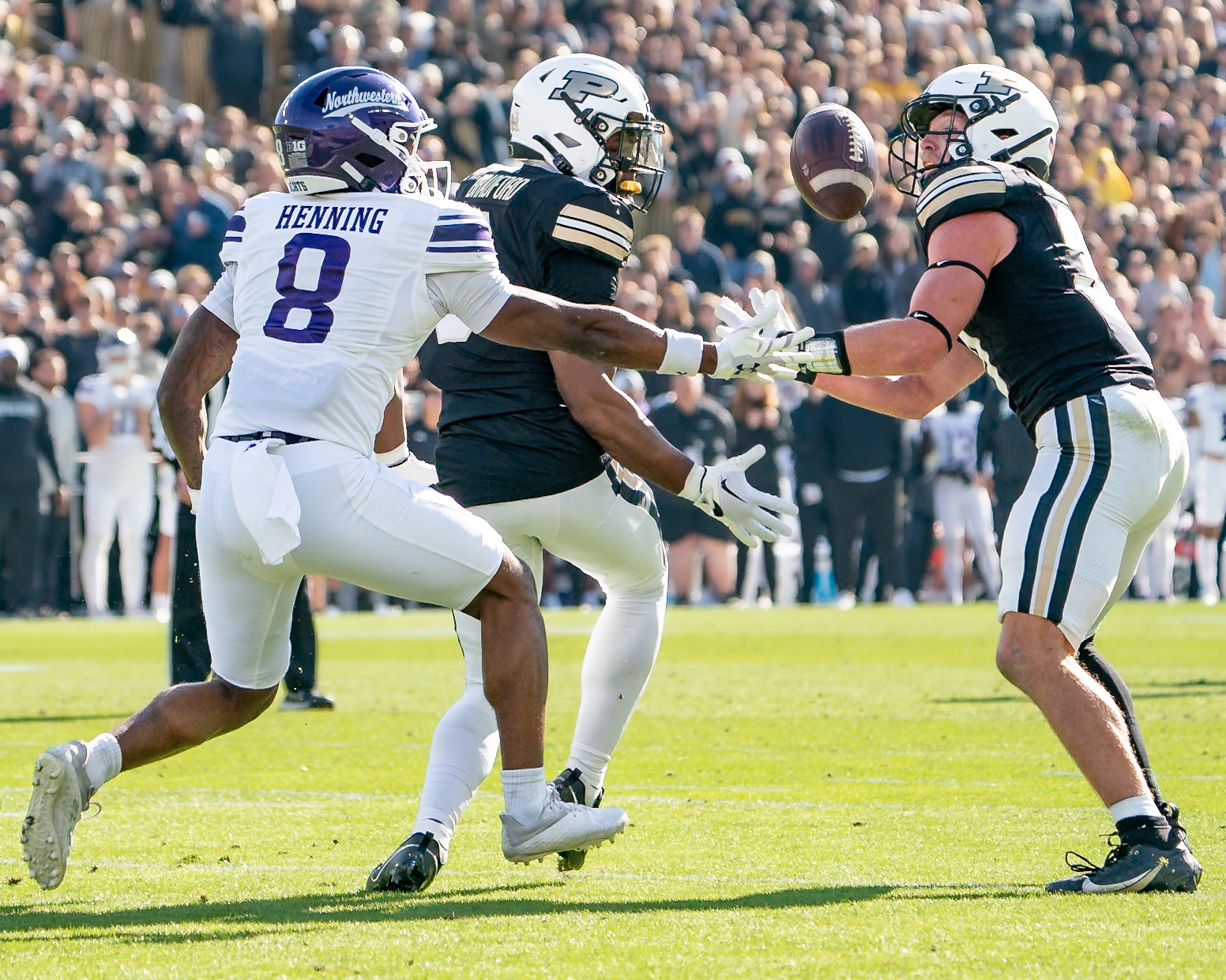 WEST LAFAYETTE, IN - NOVEMBER 2, 2024: Purdue University Freshman Defensive Back Smiley Bradford (6) and Purdue University Sophomore Defensive Back Dillon Thieneman (31) try to catch an interception against Northwestern University Wide Receiver A.J. Henning (8) during the Purdue University Boilermakers vs Northwestern University Wildcats Football game at Ross-Ade Stadium(Photo by Steve Bowen / Bowen Arrow Photography / Northern Indiana Sports Report)