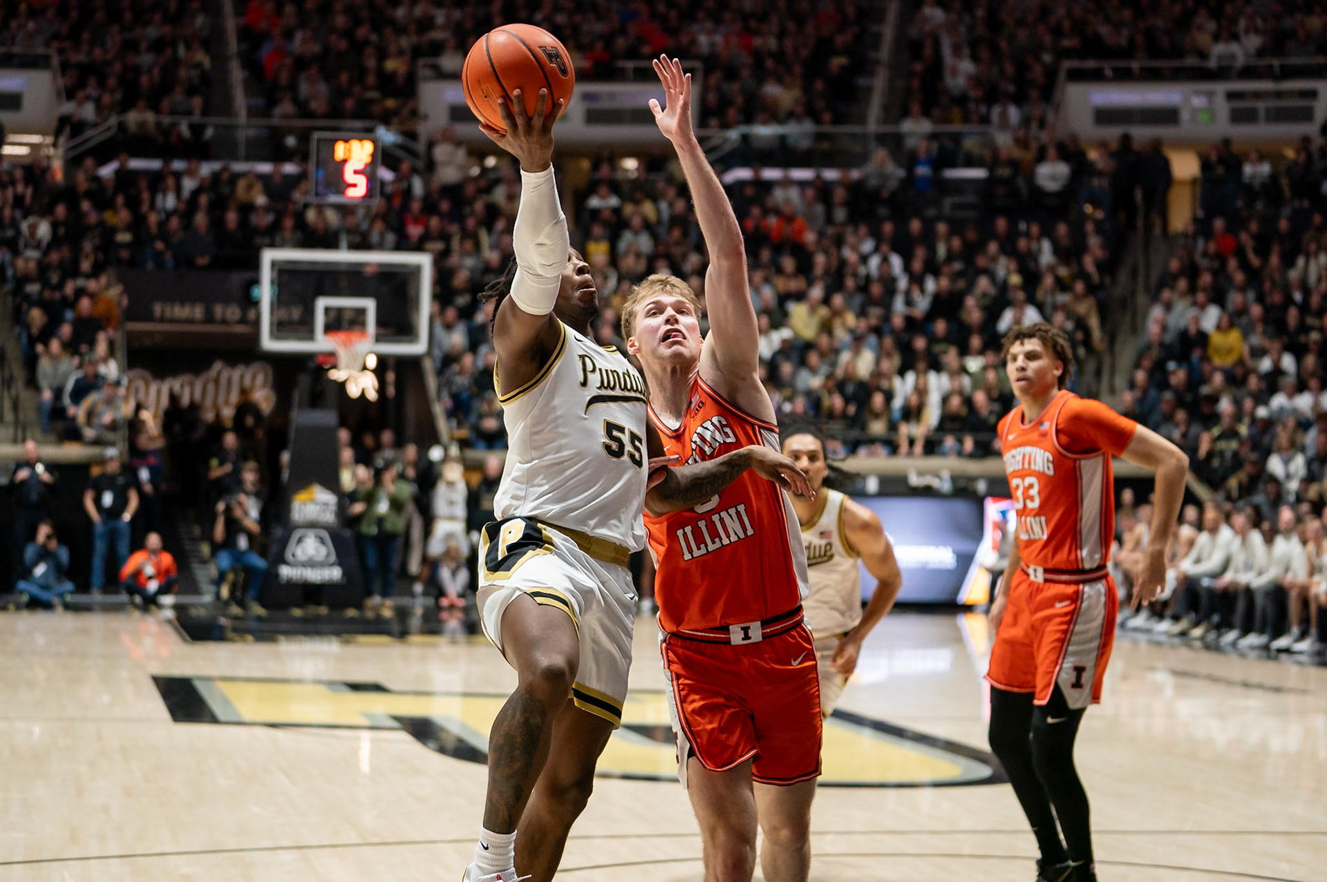 WEST LAFAYETTE, IN - JANUARY 5, 2024: Purdue 5th year Guard Lance Jones (55) driving for a layup against Illinois Graduate Guard/Forward Marcus Domask (3) in Purdue Boilermaker's Basketball vs the Illinois Fighting Illini at Mackey Arena(Photo by Steve Bowen / Bowen Arrow Photography / Northern Indiana Sports Report)