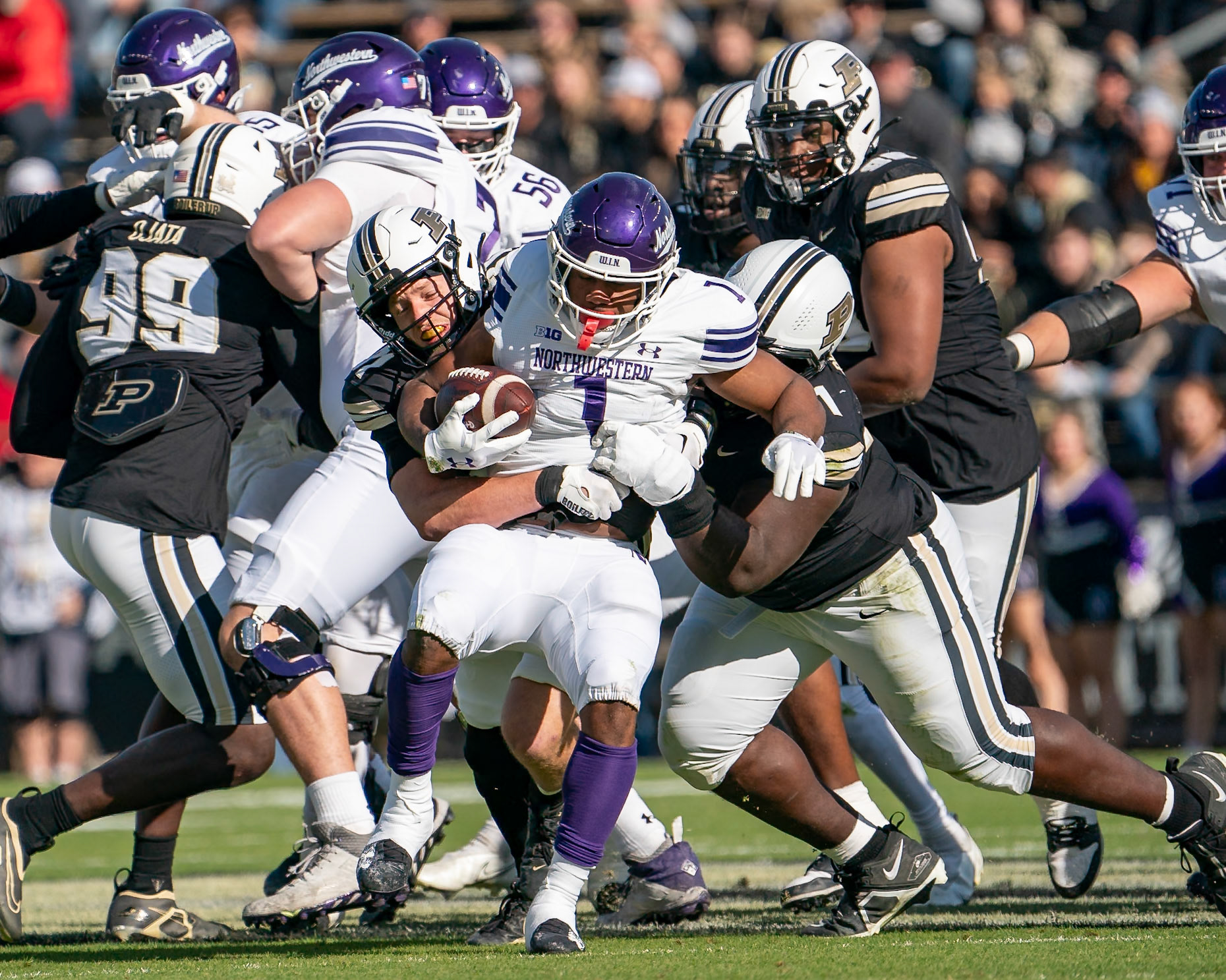 WEST LAFAYETTE, IN - NOVEMBER 2, 2024: Northwestern University Running Back Cam Porter (1) gets stuffed by Purdue University Senior Defensive Lineman Cole Brevard (91) and Purdue University Junior Linebacker Yanni Karlaftis (14) during the Purdue University Boilermakers vs Northwestern University Wildcats Football game at Ross-Ade Stadium(Photo by Steve Bowen / Bowen Arrow Photography / Northern Indiana Sports Report)