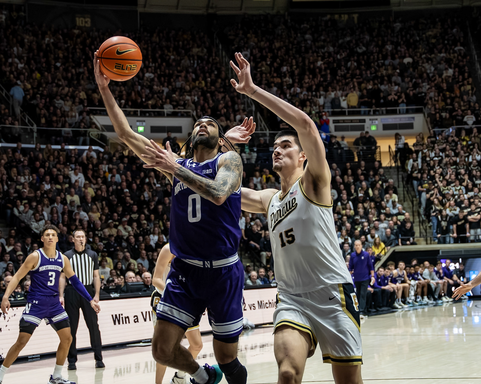 WEST LAFAYETTE, IN - JANUARY 31, 2024: Northwestern Graduate Guard Boo Buie (0), Purdue Senior Center Zach Edey (15) competing in Purdue Boilermakers Mens Basketball versus the Northwestern Wildcats at Mackey Arena(Photo by Steve Bowen / Bowen Arrow Photography / Northern Indiana Sports Report)