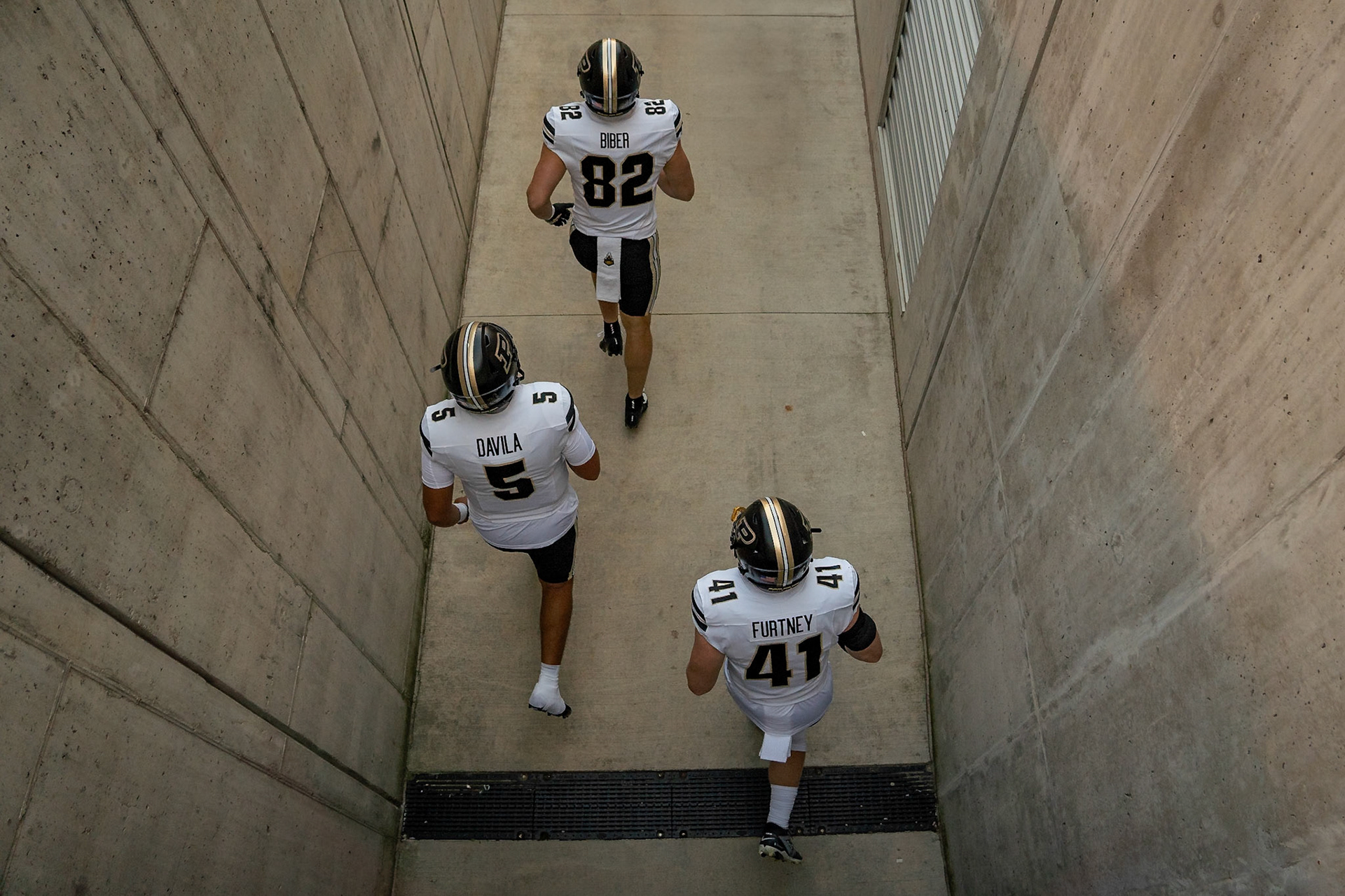 MADISON, WI - OCTOBER 5, 2024: Purdue University Junior Tight End Drew Biber (82), Purdue University Freshman Quaterback Marcos Davila (5), and Purdue University Senior Fullback Ben Furtney (41) running out to the feild during the Purdue University Boilermakers at University of Wisconsin Badger Football game at Camp Randall Stadium(Photo by Steve Bowen / NISports Report)