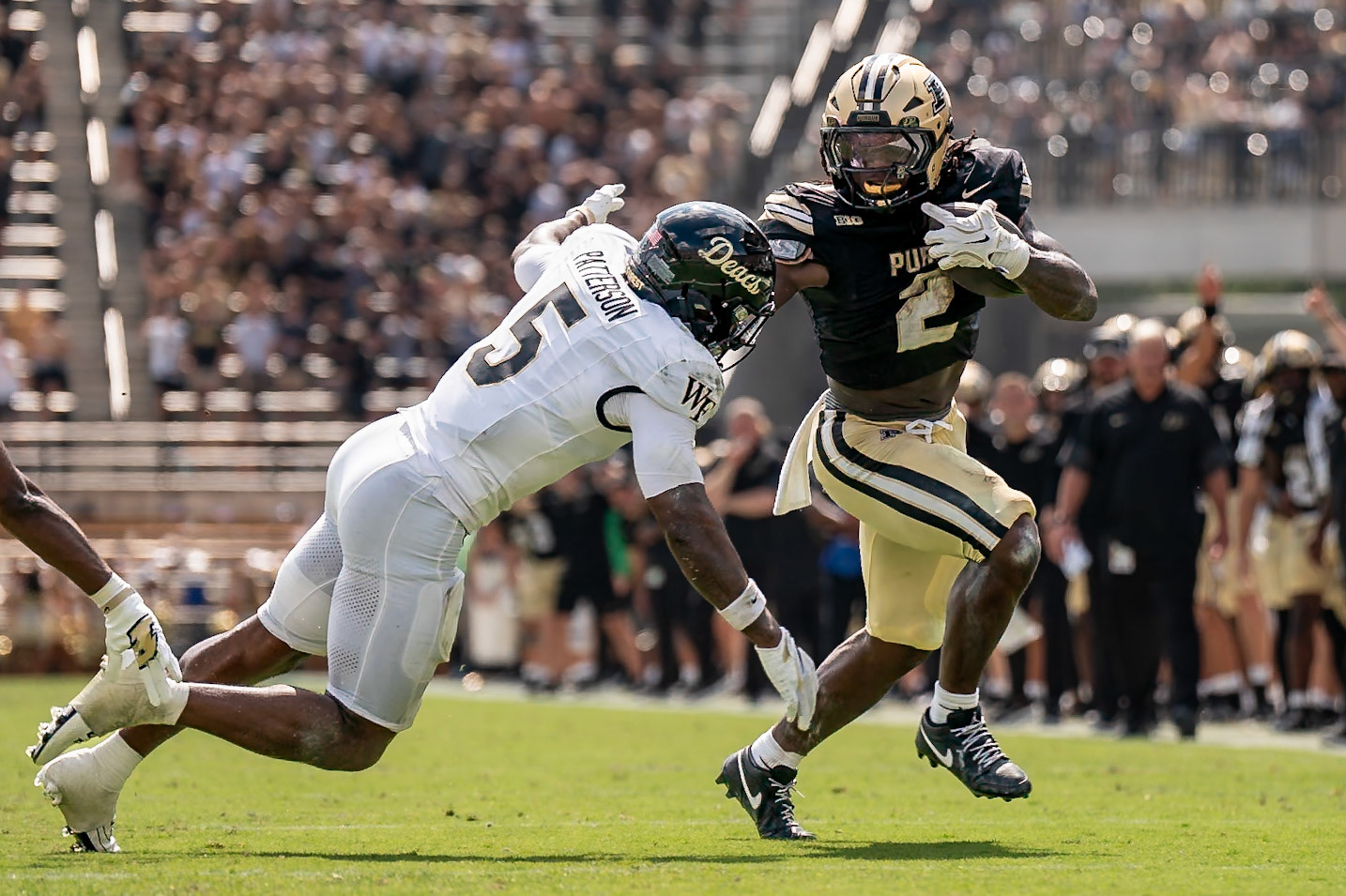 WEST LAFAYETTE, IN - SEPTEMBER 12, 2026: Purdue University Sophomore Running Back Fame Ijeboi (2) stiff arming Wake Forest University Defensive Back Davaughn Patterson (5) during at run at the Purdue Boilermakers football game vs the Wake Forest Demon Deacons at Ross-Ade Stadium(Photo by Steve Bowen / Northern Indiana Sports Report)