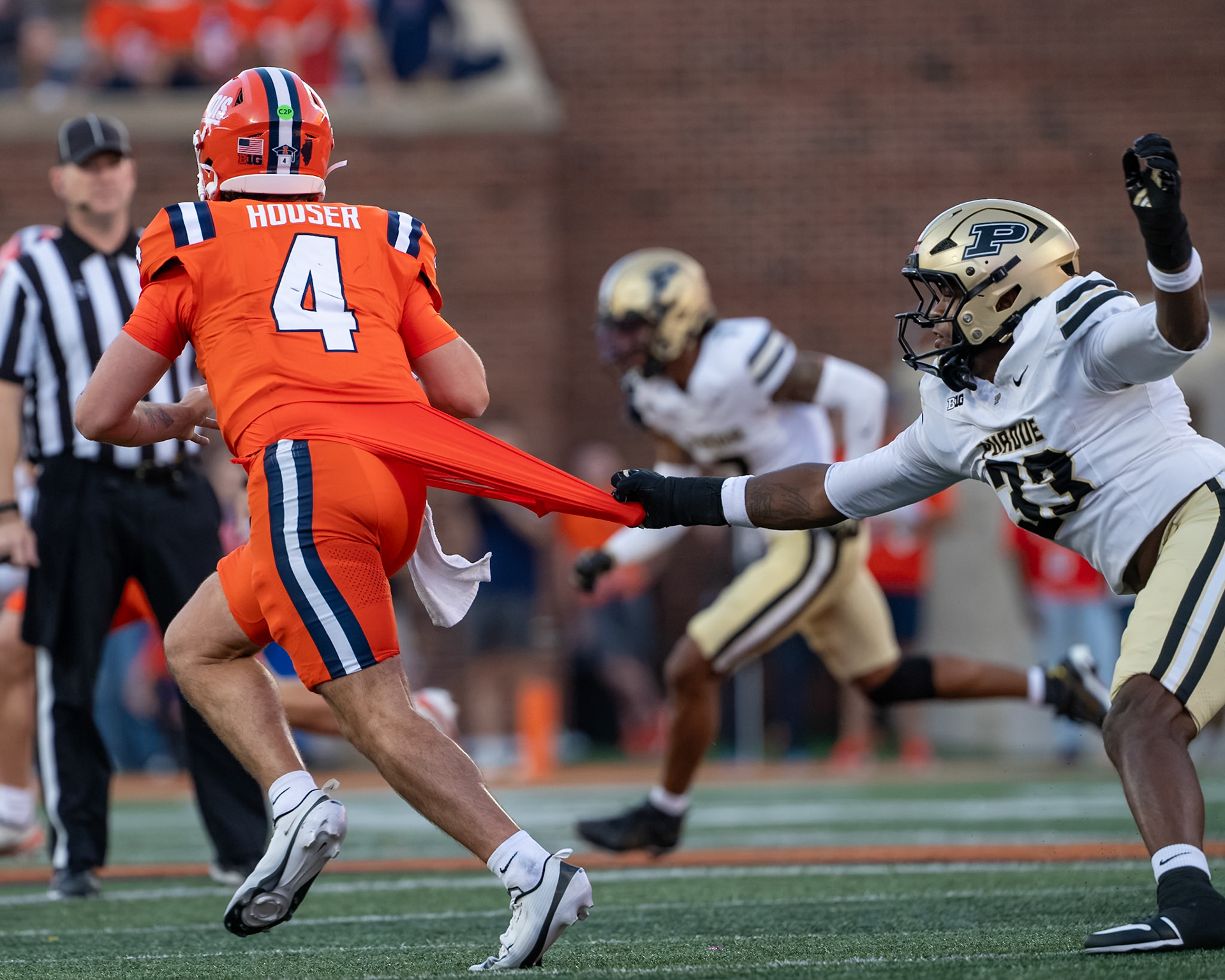 CHAMPAIGN, IL - OCTOBER 3, 2026: University of Illinois 5th Year QB Katin Houser (4), Purdue University Freshman Defensive End Jeremy Lewis (33) during the Purdue Boilermakers at Illinois Fighting Illini football game at Gies Memorial Stadium(Photo by Steve Bowen / Northern Indiana Sports Report)