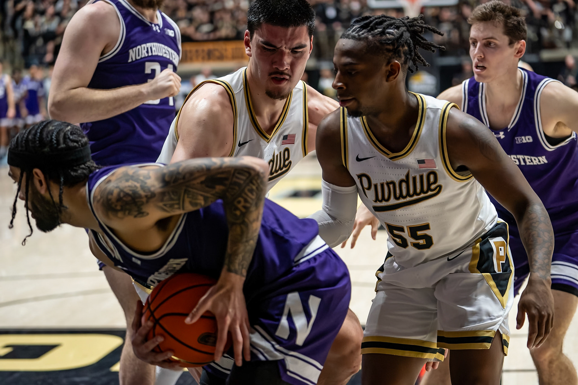 WEST LAFAYETTE, IN - JANUARY 31, 2024: Northwestern Graduate Guard Boo Buie (0), Purdue Senior Center Zach Edey (15), Purdue 5th year Guard Lance Jones (55) competing in Purdue Boilermakers Mens Basketball versus the Northwestern Wildcats at Mackey Arena(Photo by Steve Bowen / Bowen Arrow Photography / Northern Indiana Sports Report)