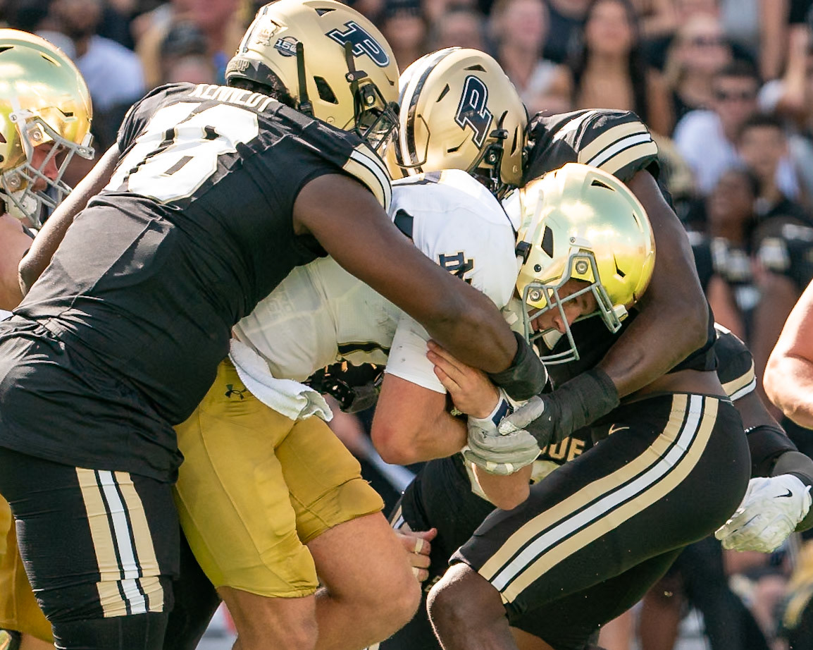 WEST LAFAYETTE, IN - SEPTEMBER 14, 2024: Purdue Fr. Defensive Lineman Demeco Kennedy (18) and Purdue Sr. Rush End Shitta Sillah (17) wrap up Notre Dame Senior QB Riley Leonard (13) when he ran up the middle during the Purdue University Boilermakers vs Notre Dame Fighting Irish Football game at Ross-Ade Stadium(Photo by Steve Bowen / Bowen Arrow Photography / Northern Indiana Sports Report)
