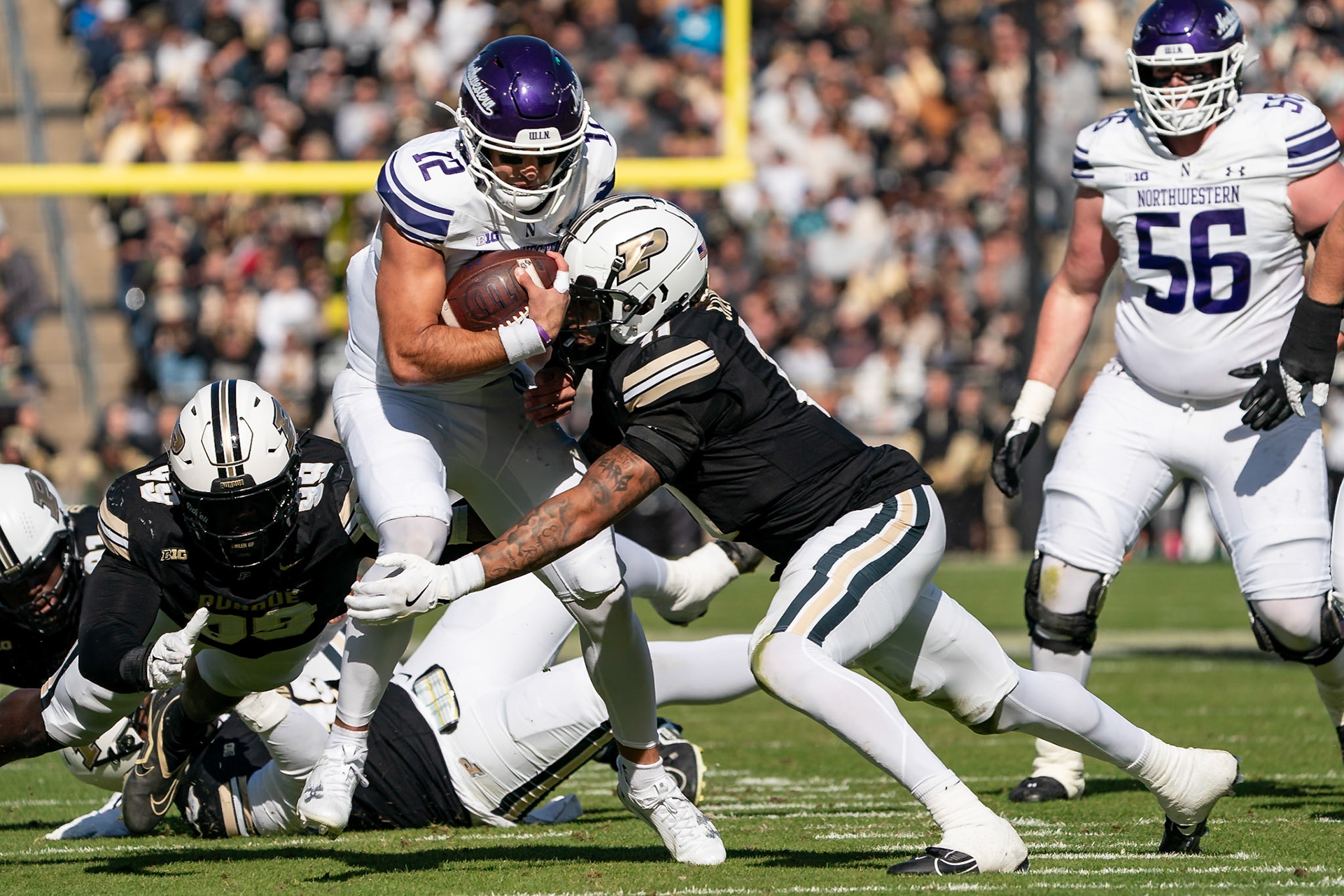 WEST LAFAYETTE, IN - NOVEMBER 2, 2024: Northwestern University Quaterback Jack Lausch (12) runs for a first down during the Purdue University Boilermakers vs Northwestern University Wildcats Football game at Ross-Ade Stadium(Photo by Steve Bowen / Bowen Arrow Photography / Northern Indiana Sports Report)