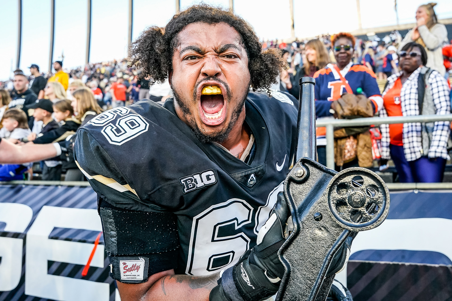 Purdue's Greg Long (69) celebrates with the cannon trophy after the victory