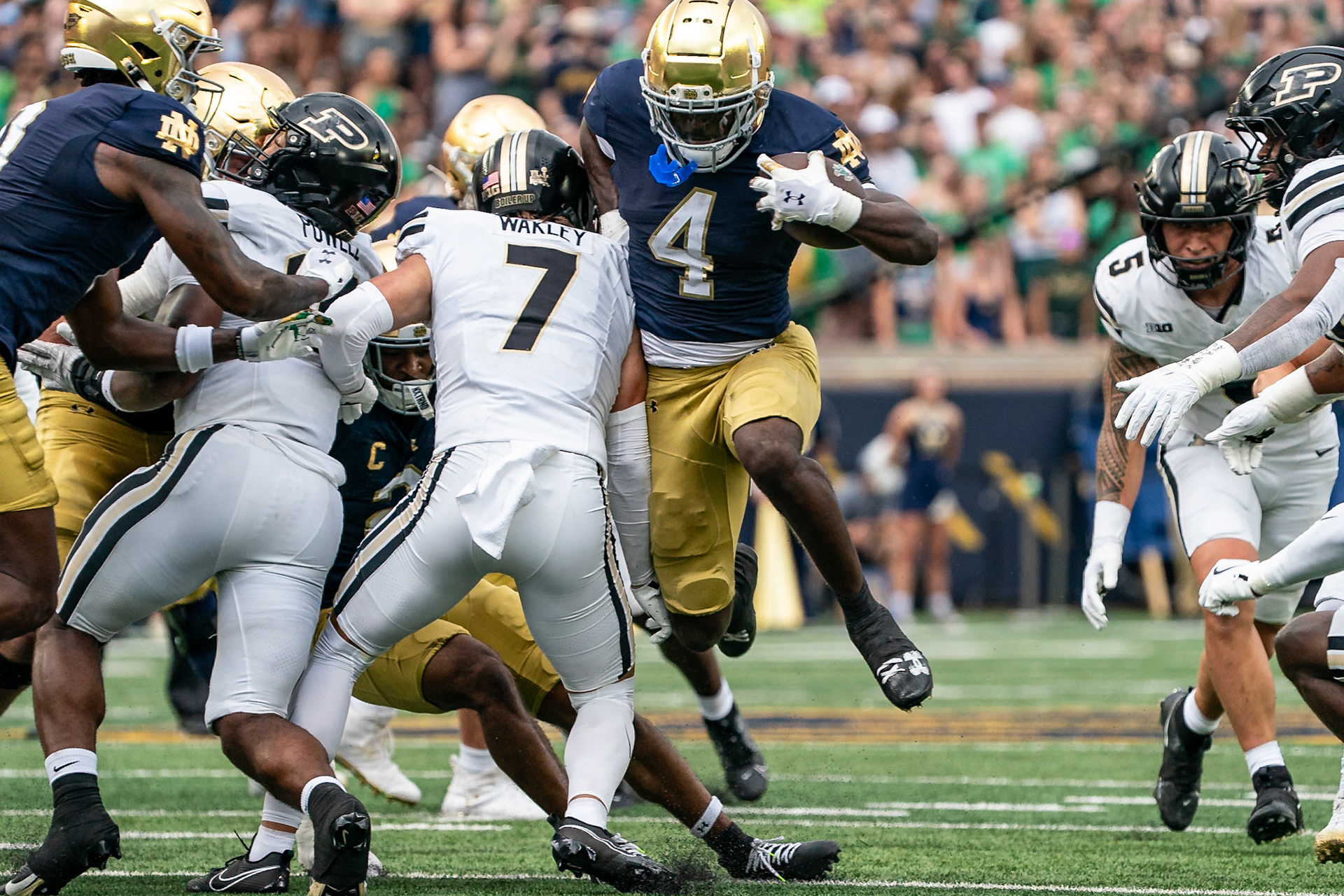SOUTH BEND, IN - SEPTEMBER 20, 2025: Notre Dame University Junior RB Jeremiyah Love (4) breaks through the line and gets past Purdue University Senior Defensive Back Crew Wakley (7) in Purdue Boilermakers at Notre Dame Fighting Irish Football at Notre Dame Stadium(Photo by Steve Bowen / Northern Indiana Sports Report)
