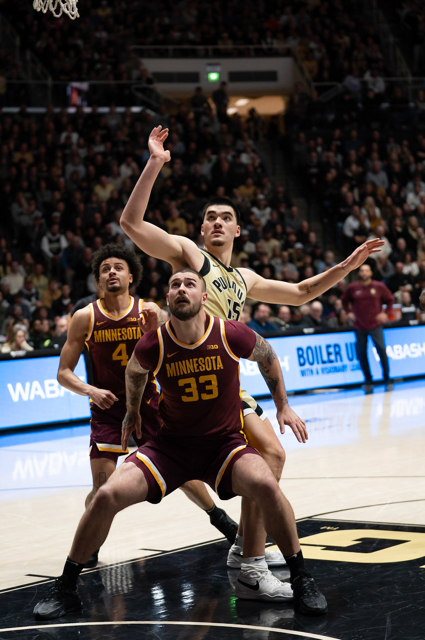 WEST LAFAYETTE, IN - FEBRUARY 15, 2024: Minnesota Graduate Center Jack Wilson (33), Purdue Senior Center Zach Edey (15) Minnesota Sophomore Guard Braeden Carrington (4) in Purdue Boilermakers Men's Basketball vs the Minnesota Golden Gophers at Mackey Arena(Photo by Steve Bowen / Bowen Arrow Photography / Northern Indiana Sports Report)