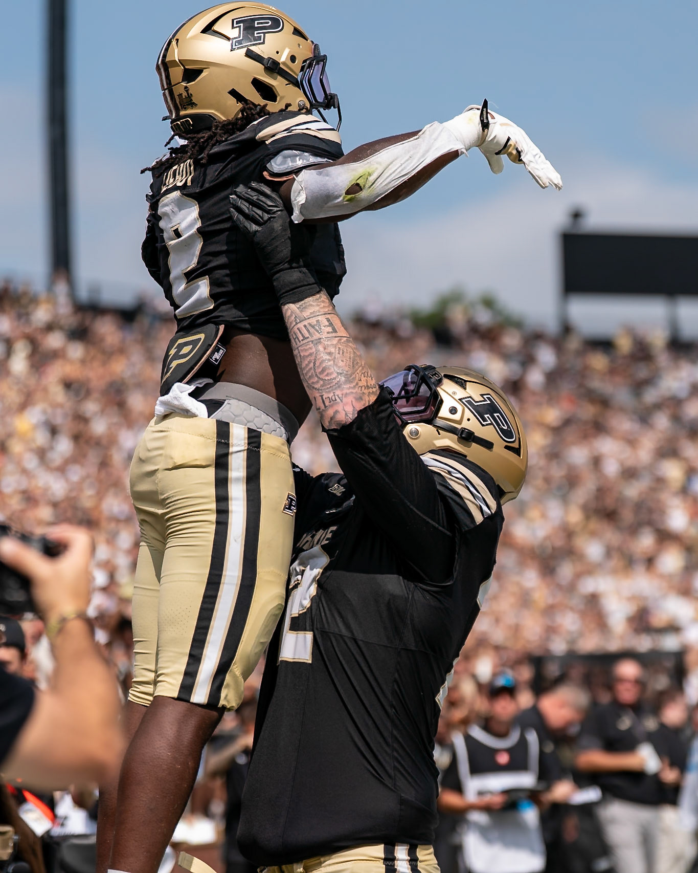 WEST LAFAYETTE, IN - SEPTEMBER 12, 2026: Purdue University Sophomore Running Back Fame Ijeboi (2) gets pushed into the air by Purdue University Freshman Offensive Lineman Jude McCoskey (72) after scoring a touchdown during the Purdue Boilermakers football game vs the Wake Forest Demon Deacons at Ross-Ade Stadium(Photo by Steve Bowen / Northern Indiana Sports Report)