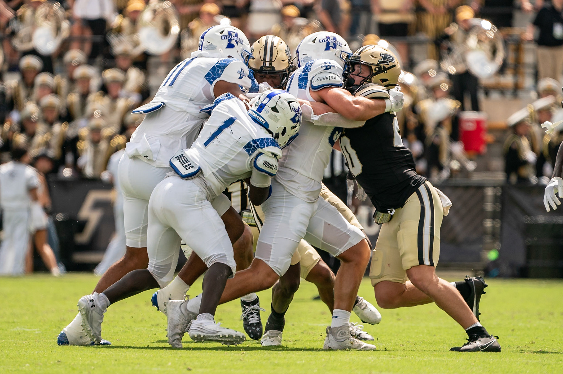 WEST LAFAYETTE, IN - AUGUST 31, 2024: Indiana State R-So. RB Plez Lawrence (1) uses his blockers as Purdue R-Fr. LB Winston Berglund (20) tries to get through the defenders in the Purdue Boilermaker Football vs Indiana State Sycamores at Ross-Ade Stadium(Photo by Steve Bowen / Bowen Arrow Photography / Northern Indiana Sports Report)