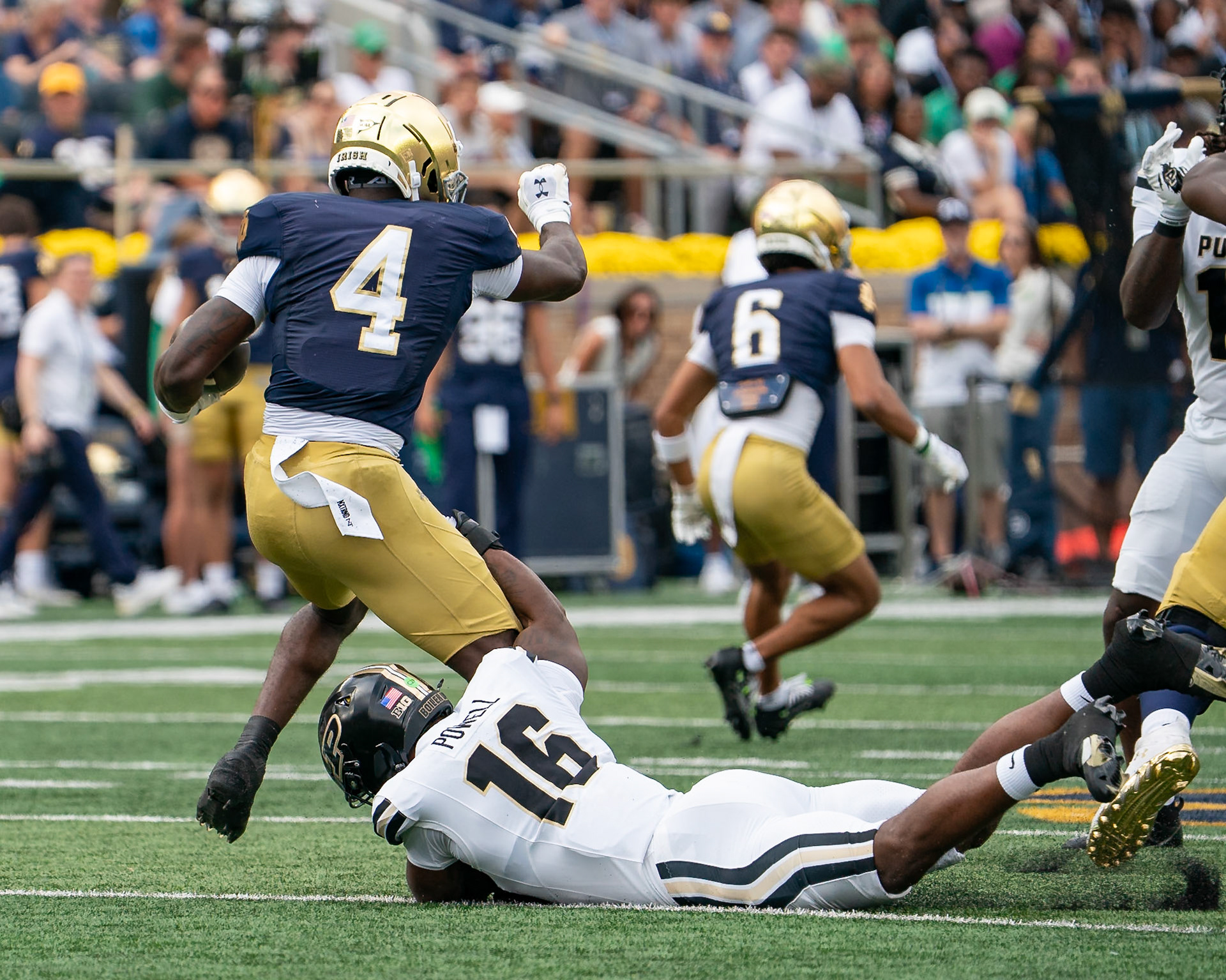 SOUTH BEND, IN - SEPTEMBER 20, 2025: Purdue University Senior Linebacker Mani Powell (16) holds on to the leg of Notre Dame University's Junior RB Jeremiyah Love (4) during the Purdue Boilermakers vs Notre Dame Fighting Irish Football at Notre Dame Stadium(Photo by Steve Bowen / Northern Indiana Sports Report)