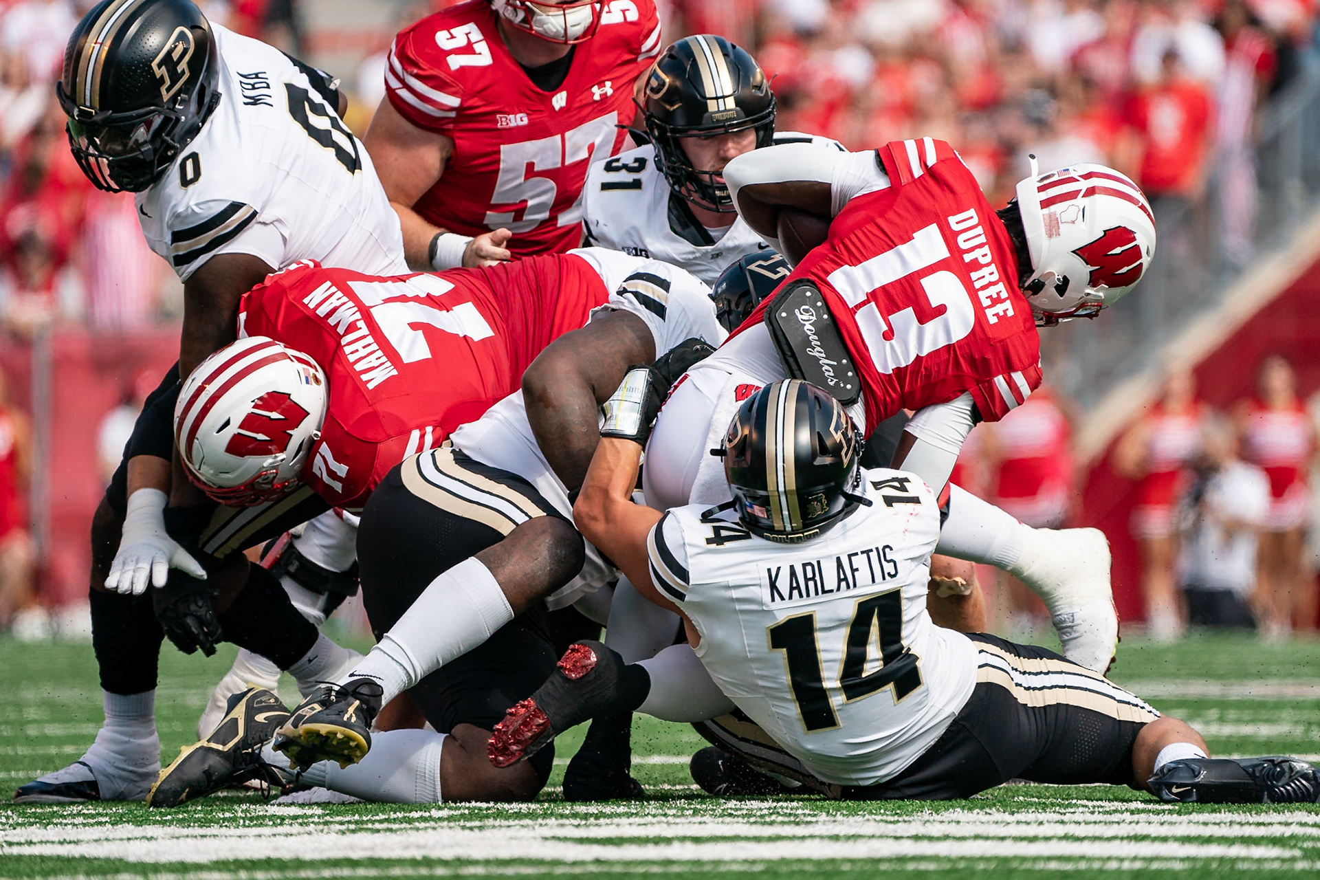 MADISON, WI - OCTOBER 5, 2024: University of Wisconsin Freshman RB Darrion Dupree (13) being tackled by Purdue University Junior Linebacker Yanni Karlaftis (14) during the Purdue University Boilermakers at University of Wisconsin Badger Football game at Camp Randall Stadium(Photo by Steve Bowen / NISports Report)