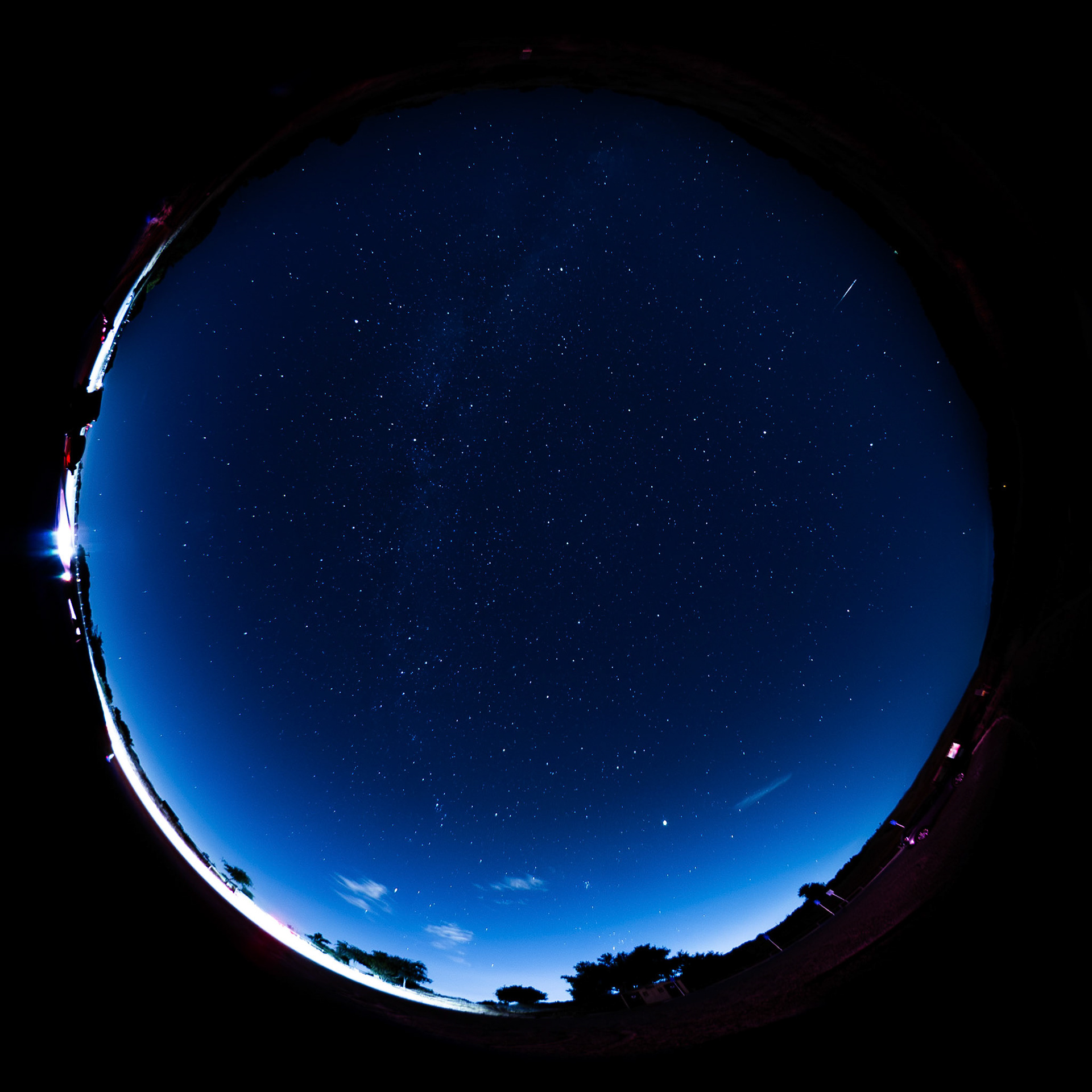 Fisheye view of the entire night sky, with a meteor visible in the upper right corner
