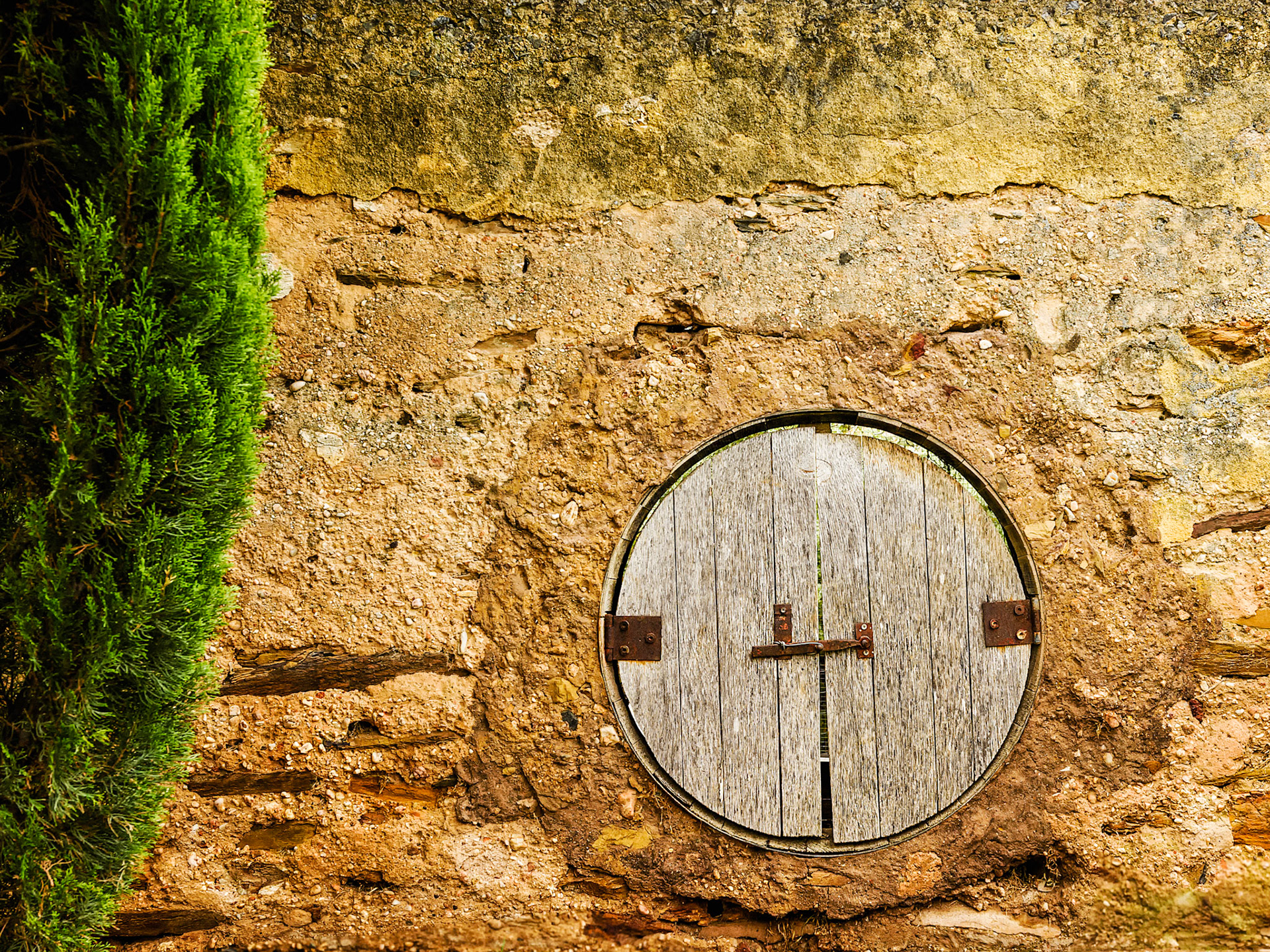 Title: Hole in the Wall / Caption: Another use for old wine barrels. Stone Wall in a small vineyard in McLaren Vale, South Australia