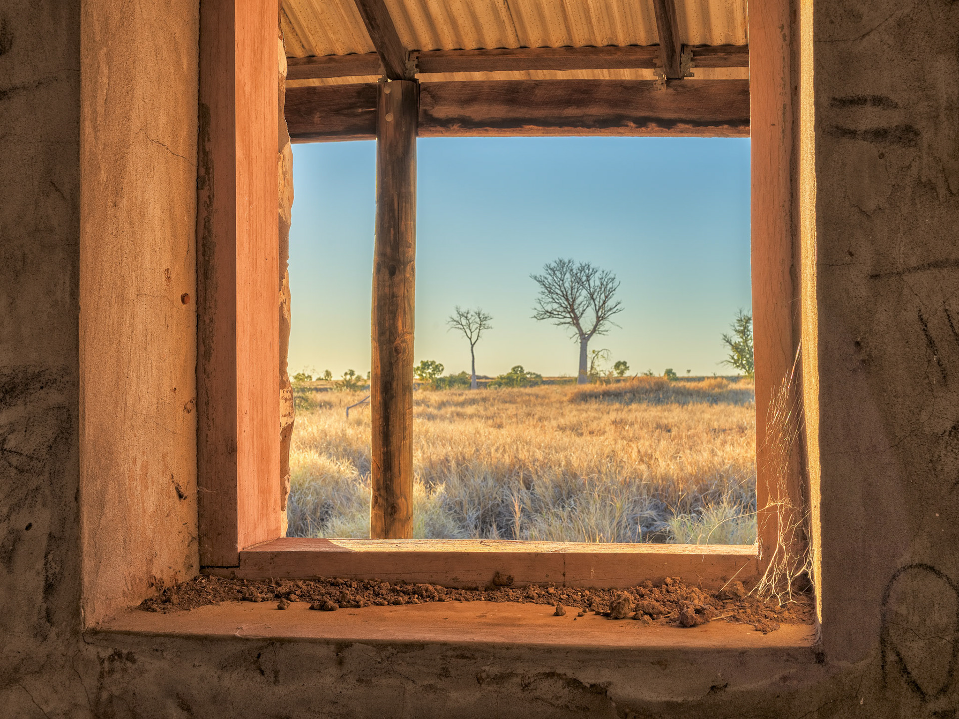 Yester Year / As you gaze through this window set in the solid stone walls it is easy to imagine someone at your shoulder talking about the things they saw and did here in years gone by. The old Ord River Station homestead along Duncan Road in the East Kimberleys, Western Australia.