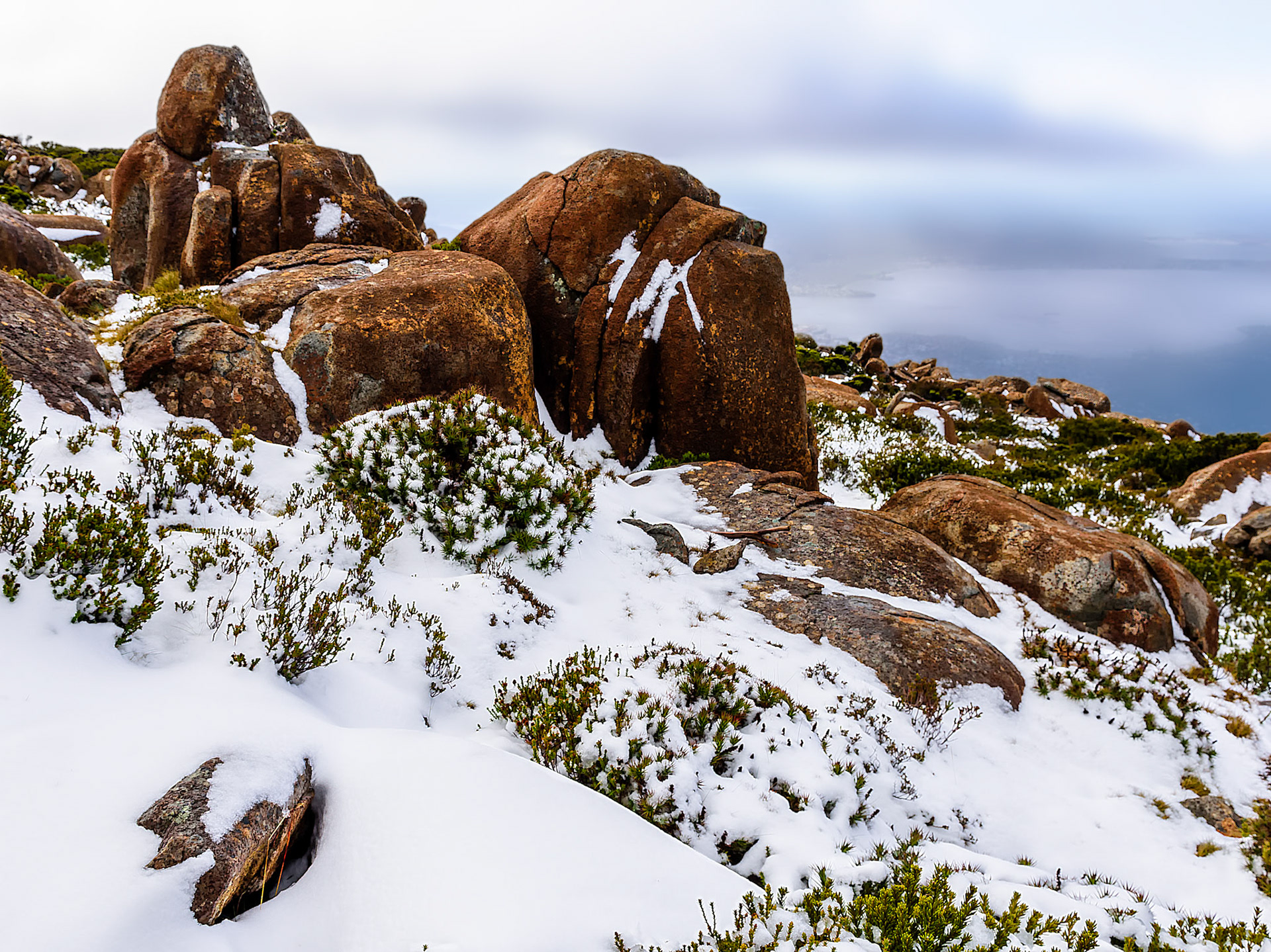 Snow and Rocks #1 / I visited Mt Wellington above Hobart on a very windy day in May. I had to wait three hours before the road  opened and I could drive to the top. Tasmania, Australia