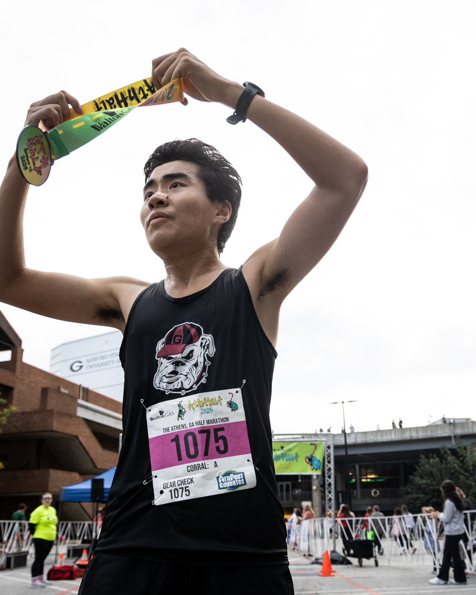 Charles Wu collects his medal after crossing the finish line at the AthHalf half marathon in Athens, Georgia on Sunday, Oct. 12, 2025. AthHalf is a fundraiser for Athfest Educates, which awards grants to schools, nonprofits and government agencies. (Photo/Emily Laycock)