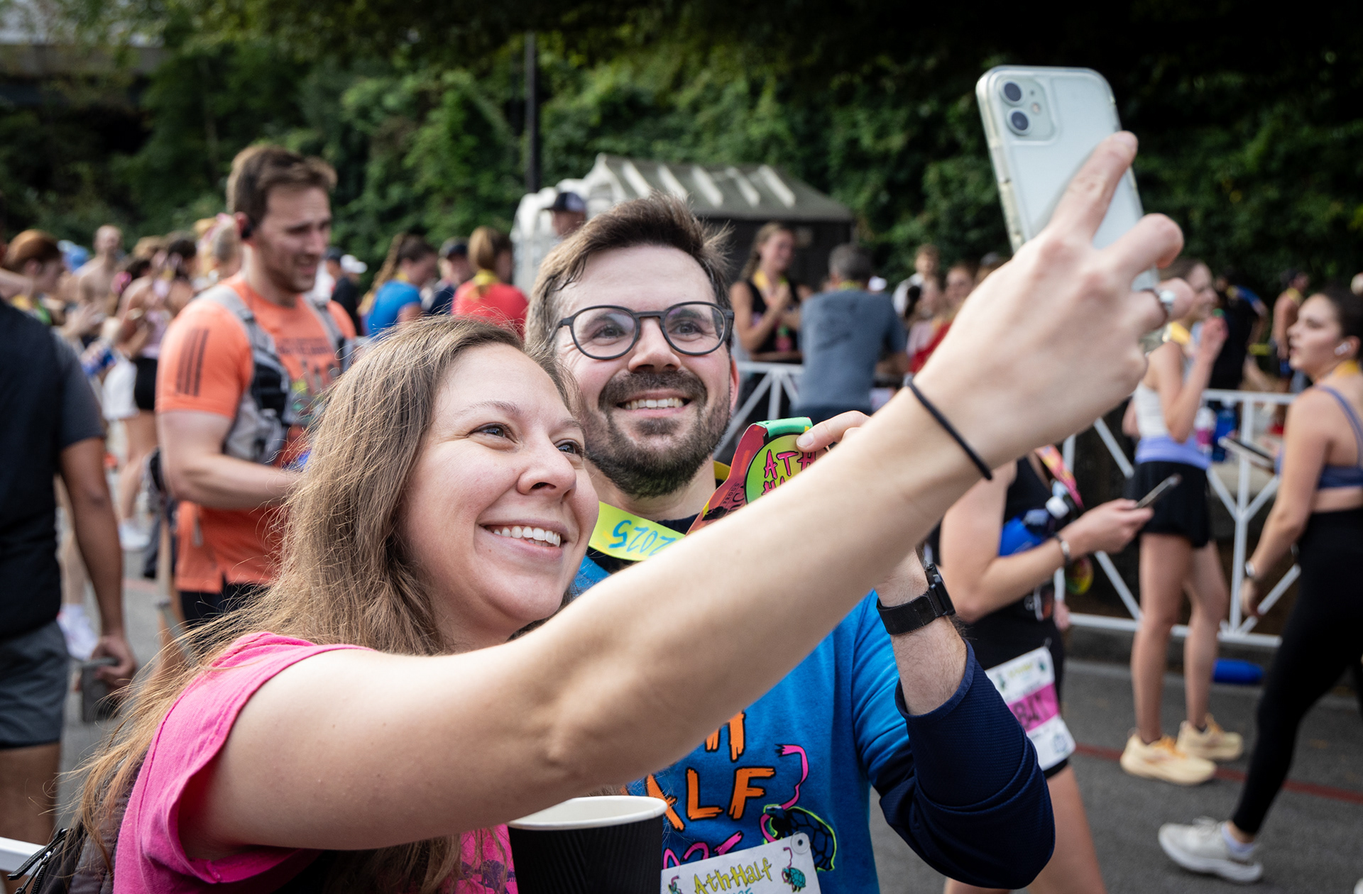 A runner celebrates after crossing the finish line at the AthHalf half marathon in Athens, Georgia on Sunday, Oct. 12, 2025. AthHalf is a fundraiser for Athfest Educates, which awards grants to schools, nonprofits and government agencies. (Photo/Emily Laycock)