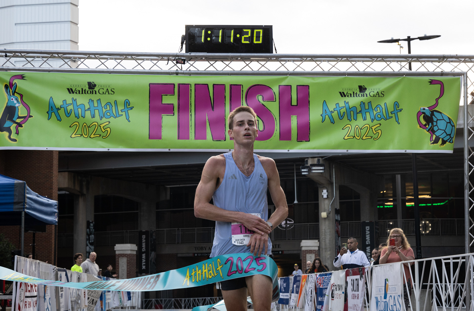 Male winner, Gray Frederick, crosses the finish line at the AthHalf half marathon in Athens, Georgia on Sunday, Oct. 12, 2025. Frederick won with a time of 1 hour, 11 minutes, 18 seconds. (Photo/Emily Laycock)