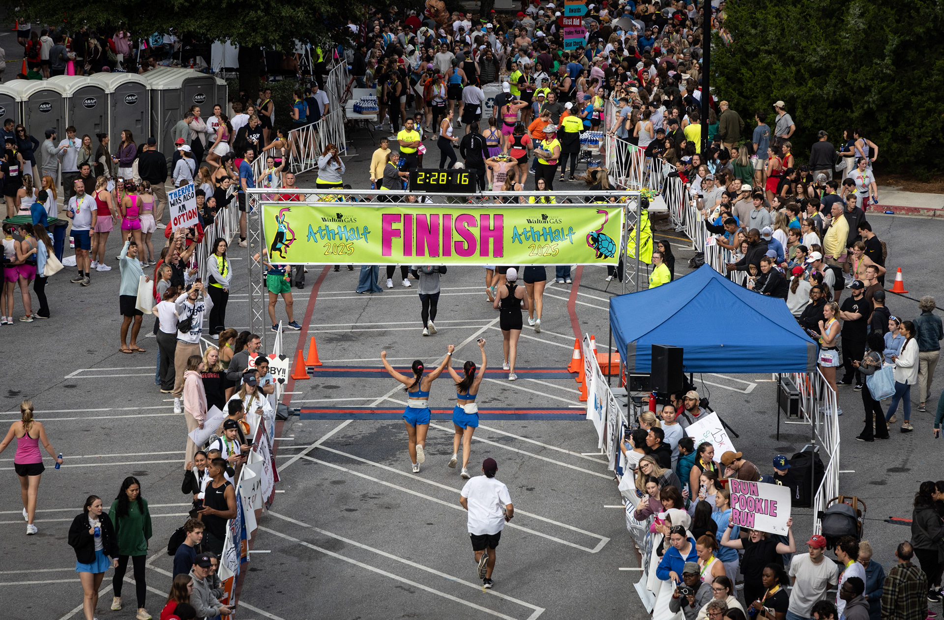 Runners celebrate as they cross the finish line at the AthHalf half marathon in Athens, Georgia on Sunday, Oct. 12, 2025. AthHalf is a fundraiser for Athfest Educates, which awards grants to schools, nonprofits and government agencies. (Photo/Emily Laycock)