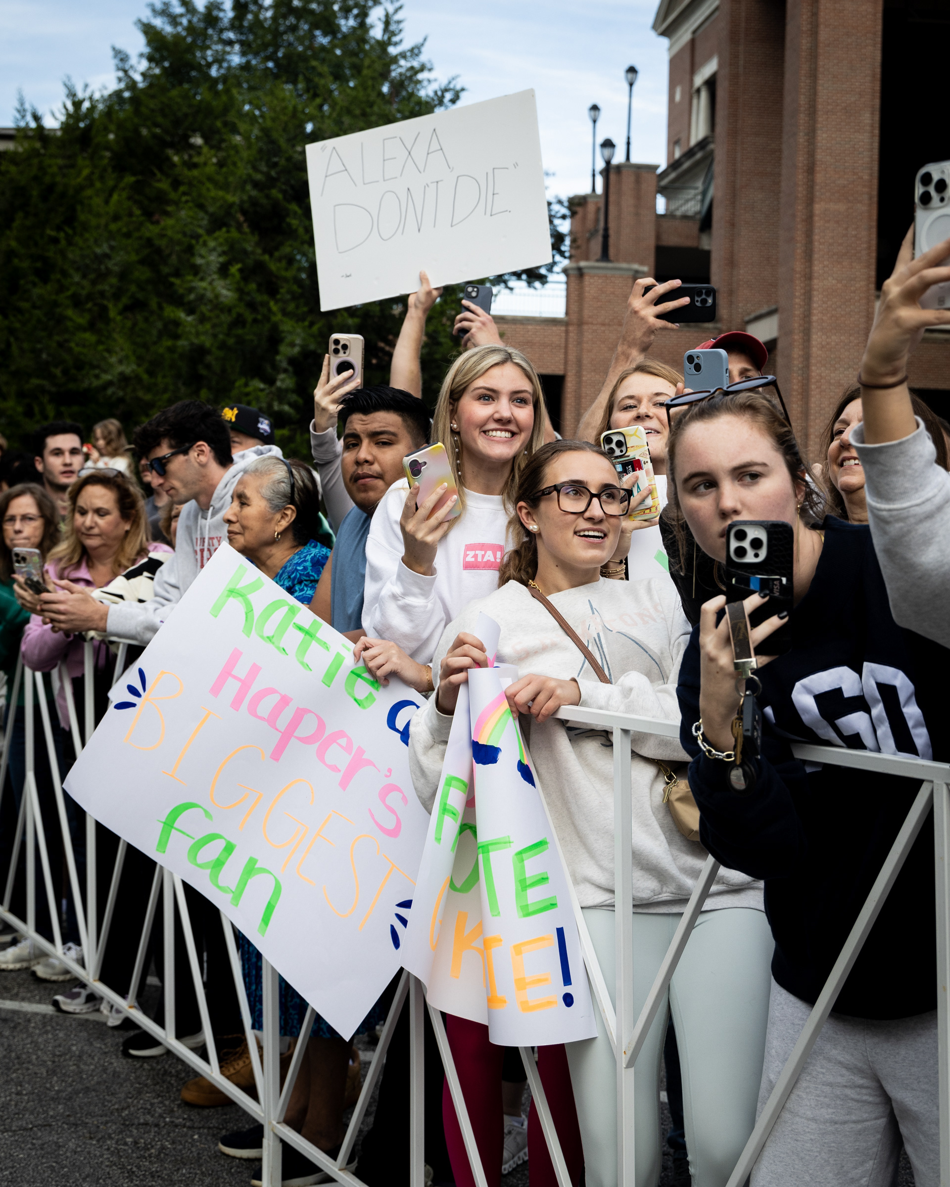 Spectators hold posters at the finish line of the AthHalf half marathon in Athens, Georgia on Sunday, Oct. 12, 2025. AthHalf is a fundraiser for Athfest Educates, which awards grants to schools, nonprofits and government agencies. (Photo/Emily Laycock)