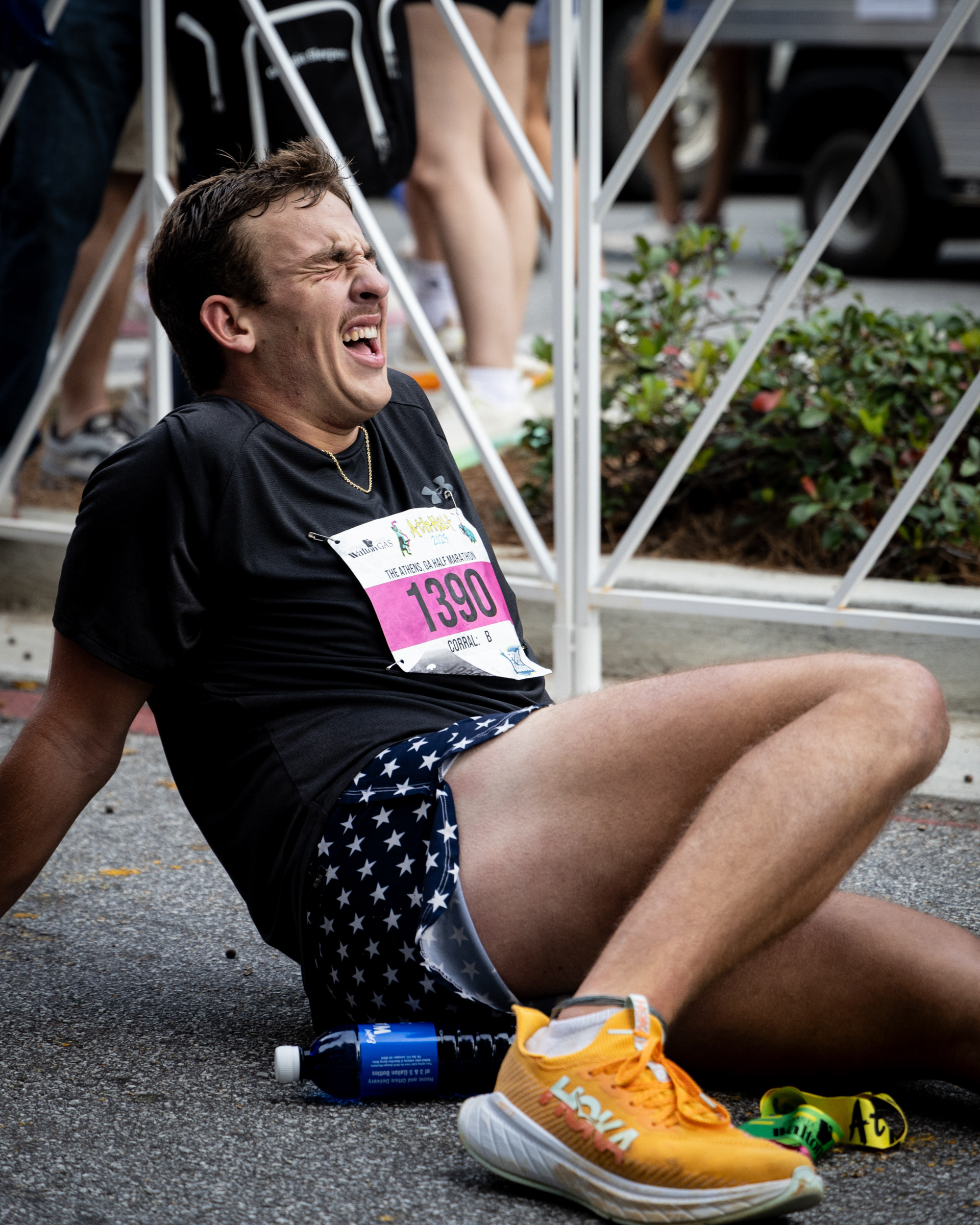 Caleb Lowe rests after crossing the finish line at the AthHalf half marathon in Athens, Georgia on Sunday, Oct. 12, 2025. AthHalf is a fundraiser for Athfest Educates, which awards grants to schools, nonprofits and government agencies. (Photo/Emily Laycock