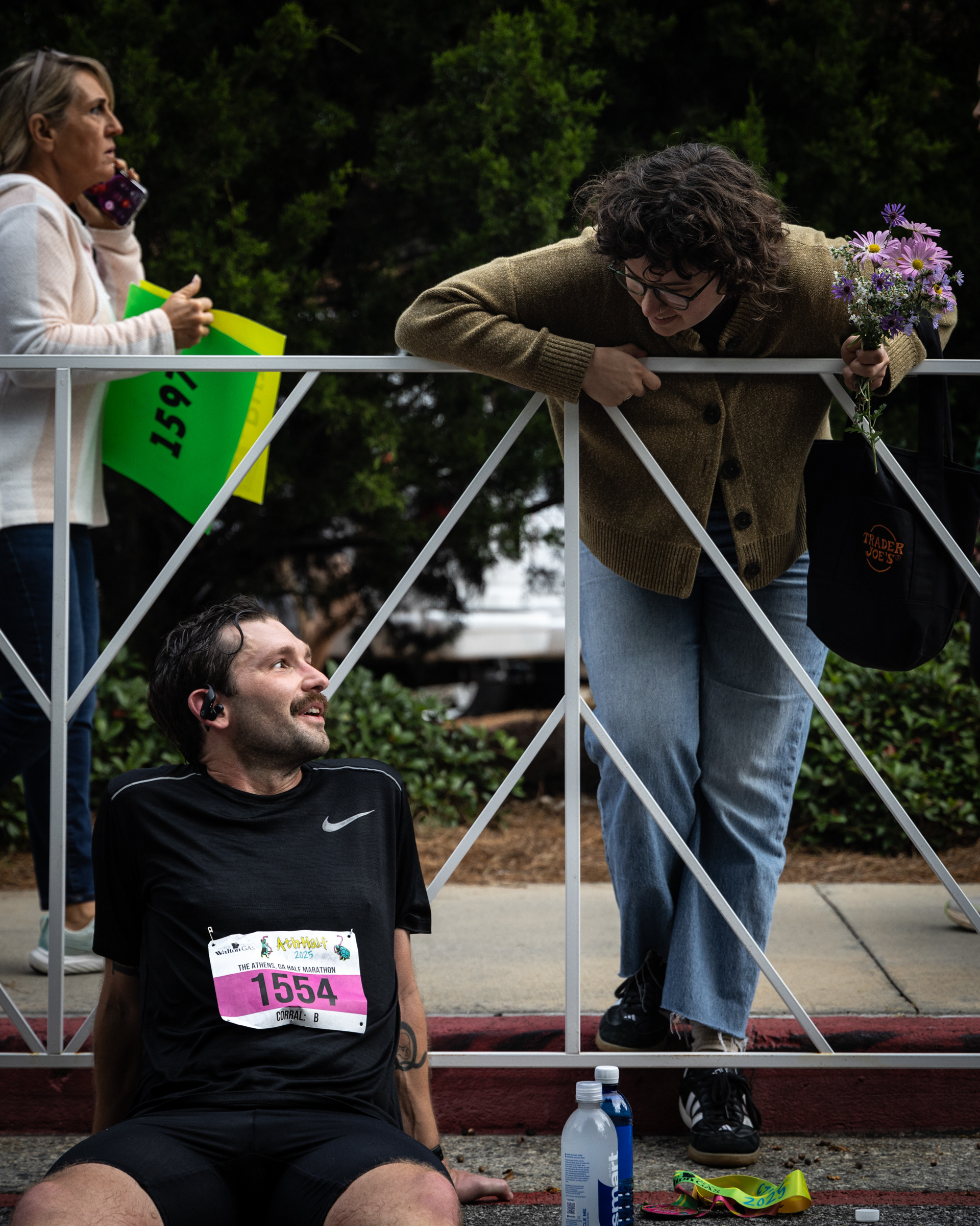 Foster Tyler Elrod rests after crossing the finish line at the AthHalf half marathon in Athens, Georgia on Sunday, Oct. 12, 2025. AthHalf is a fundraiser for Athfest Educates, which awards grants to schools, nonprofits and government agencies. (Photo/Emily Laycock)